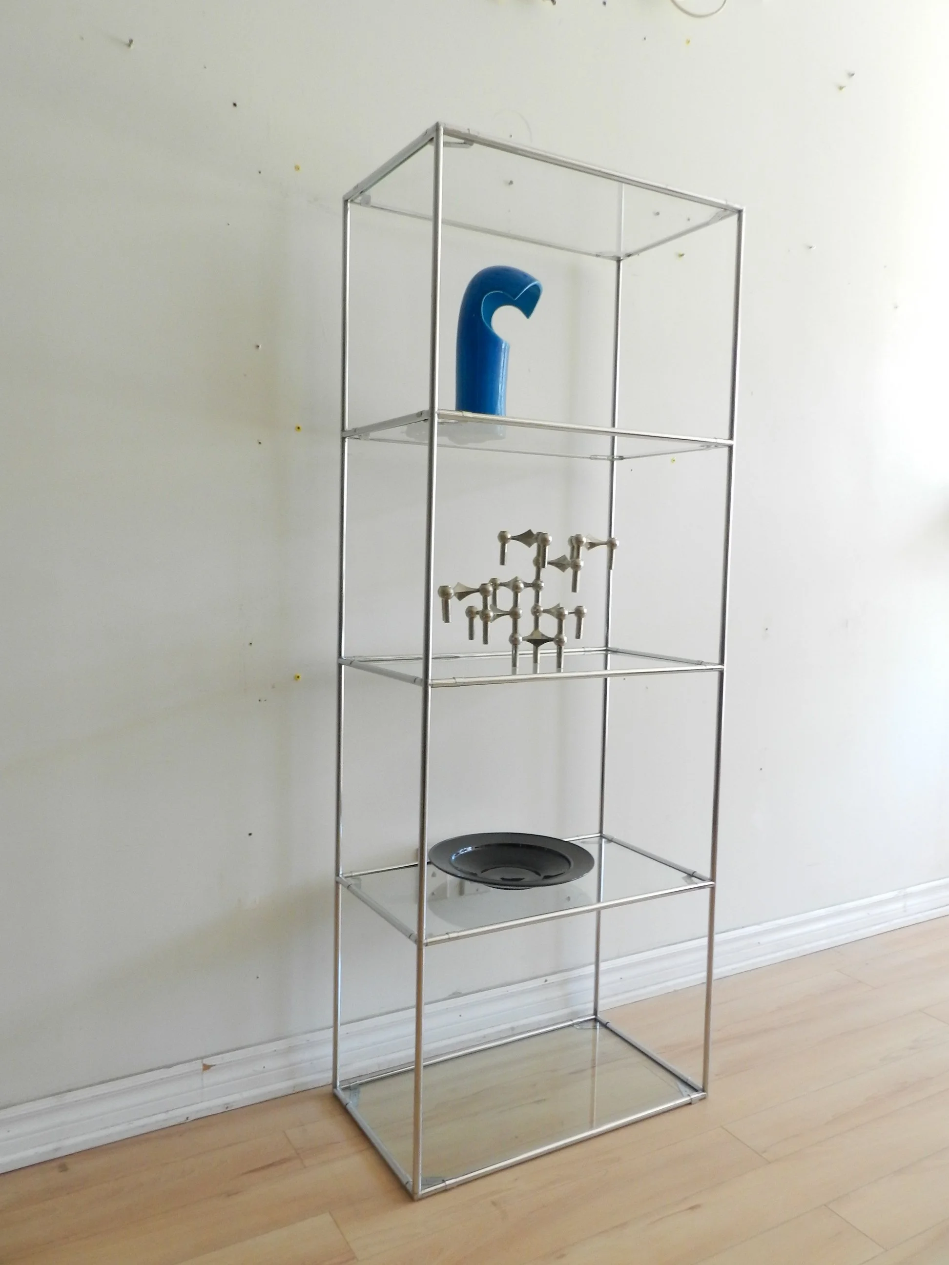 Pair of Abstracta chrome and glass modular shelf units designed by Poul Cadovius for Royal System.  Denmark, 1970s.