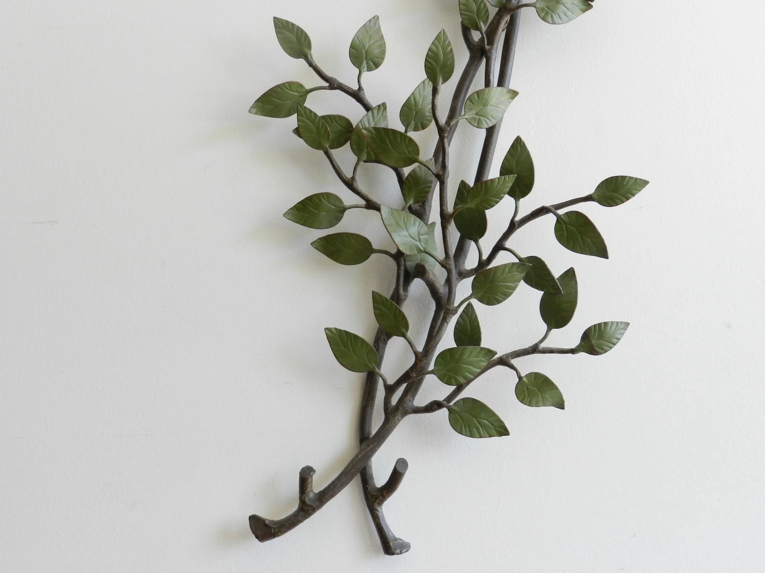 Vintage high quality wall sculpture of branch with leaves in painted metal.  circa 1940s.