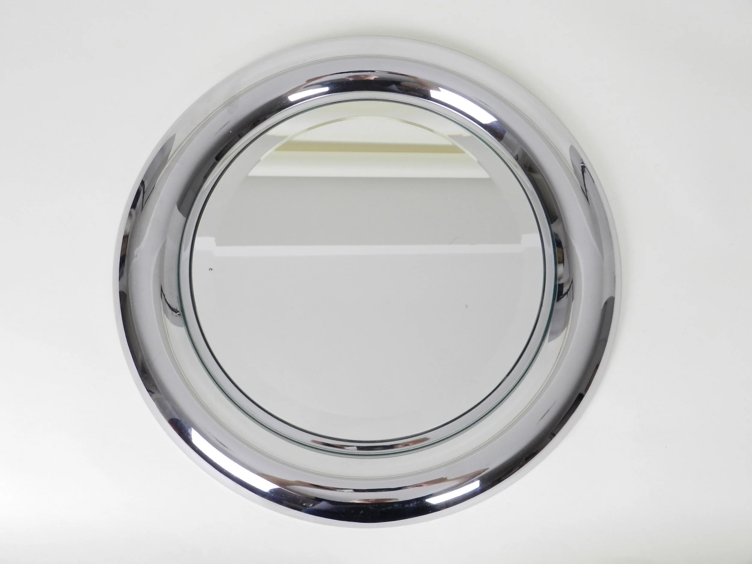 Modernist wall mirror with chromed steel frame by Reggiani.  Italy, 1970s.