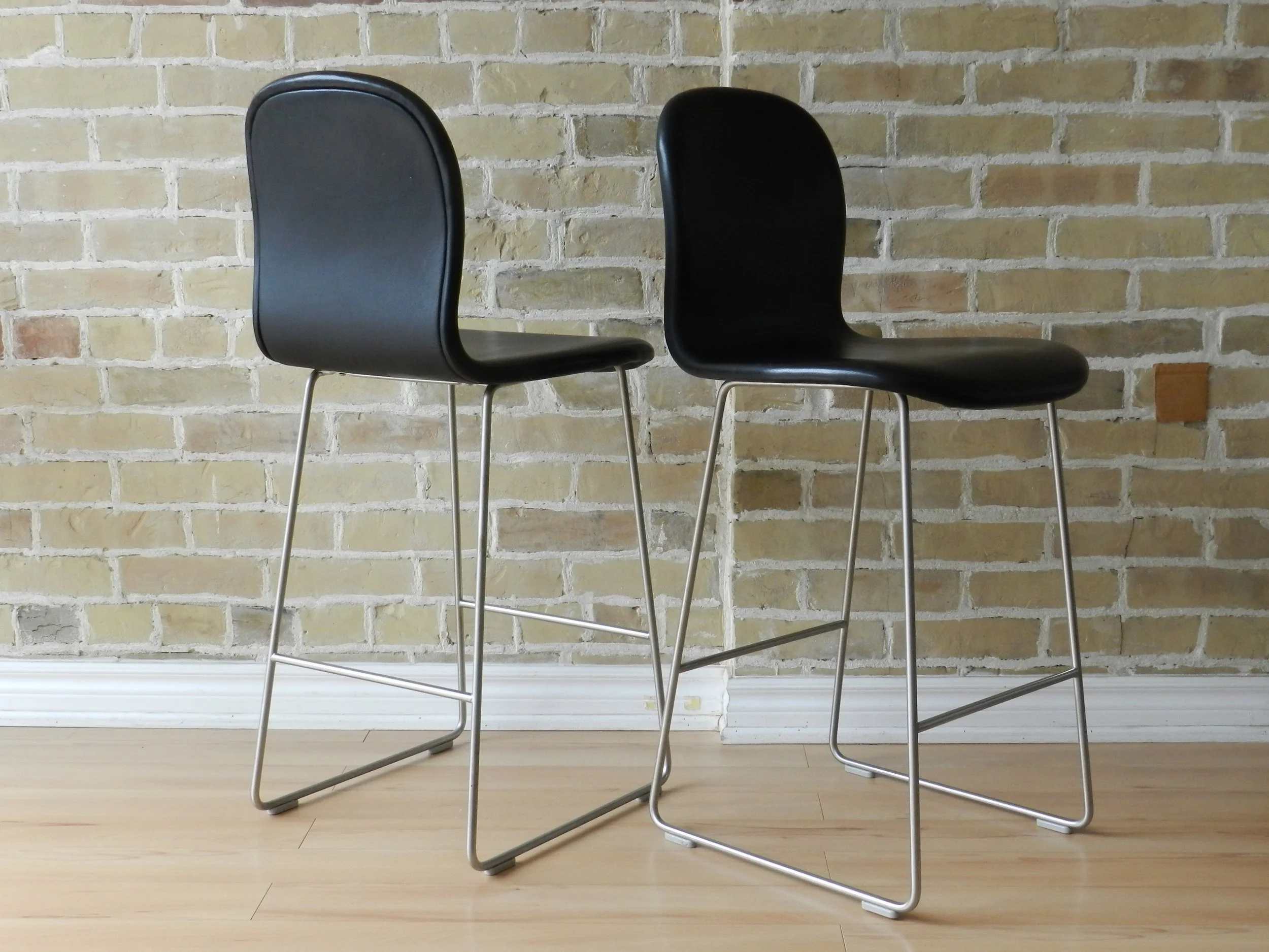 Set of four Tate Soft stools designed by Jasper Morrson for Cappellini. Black leather upholstery on steel base. Counter height.  Italy, 2021.