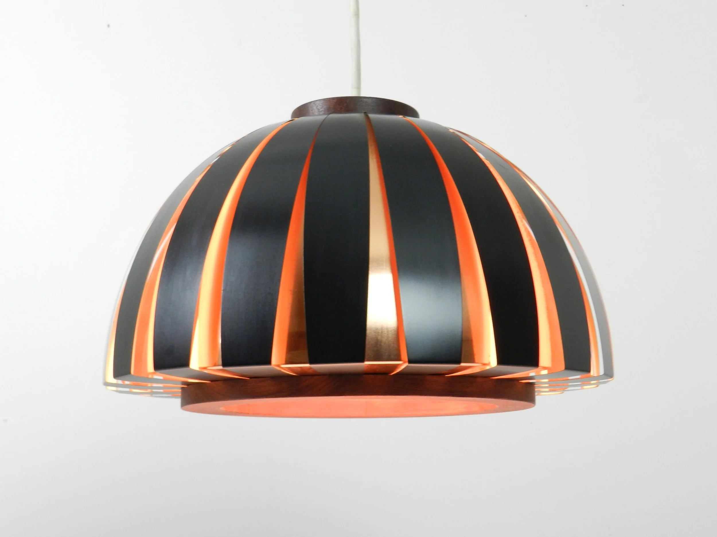 Fiesta pendant lamp designed by Svend Aage Holm Sorensen. Copper, enameled metal and teak.  Denmark, 1960s.