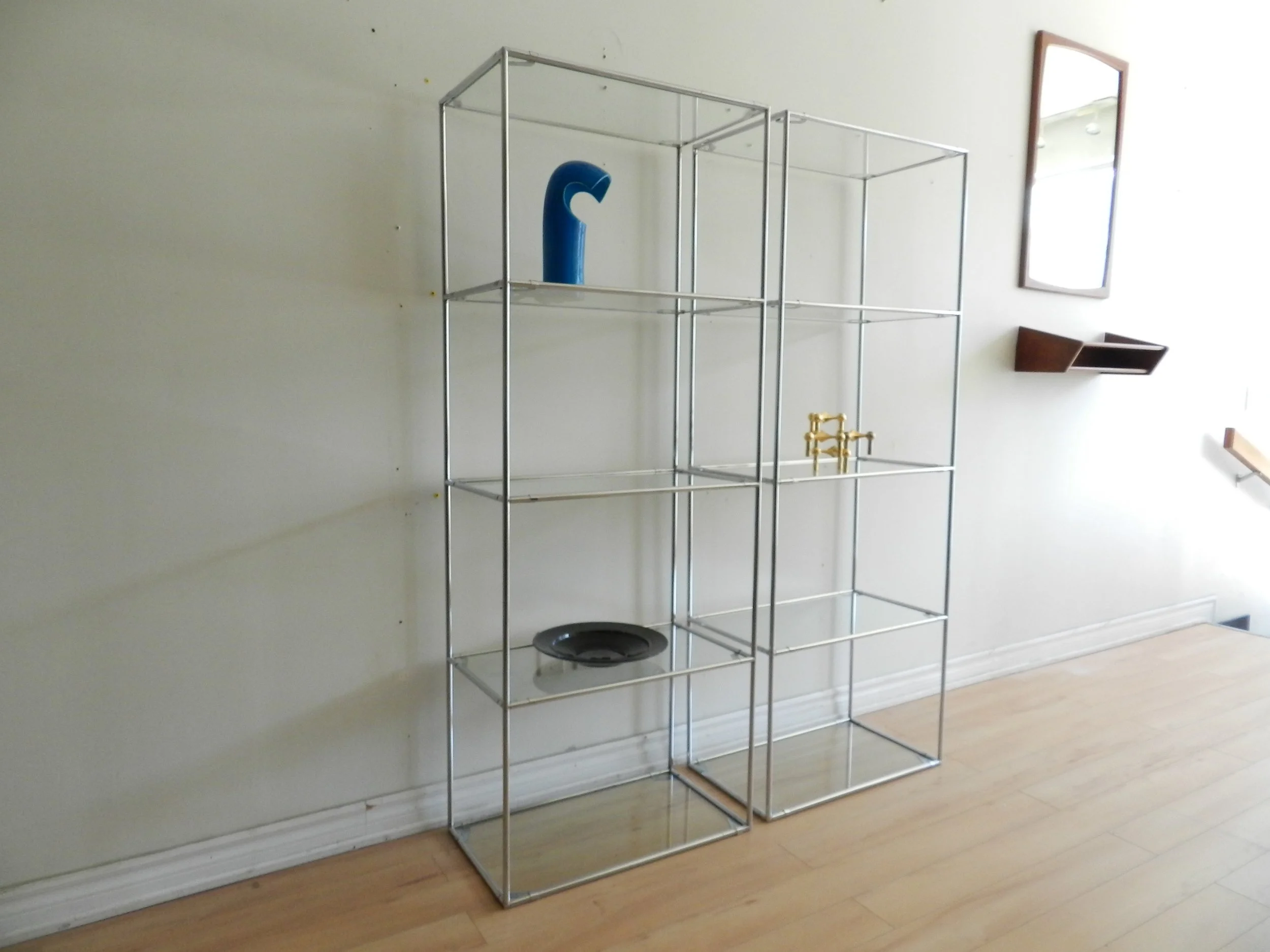 Pair of Abstracta chrome and glass modular shelf units designed by Poul Cadovius for Royal System.  Denmark, 1970s.