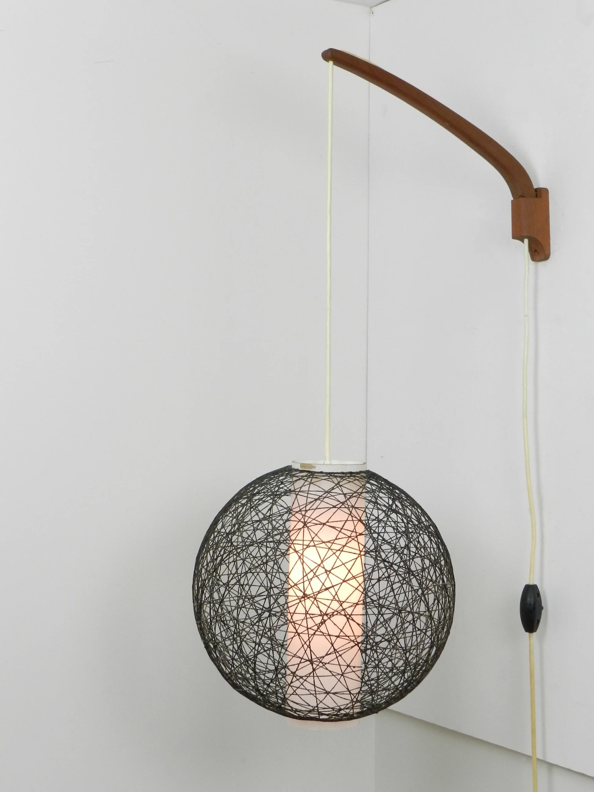 Scandinavian mid century wall lamp in teak with glass and string shade.  Finland, 1960s.