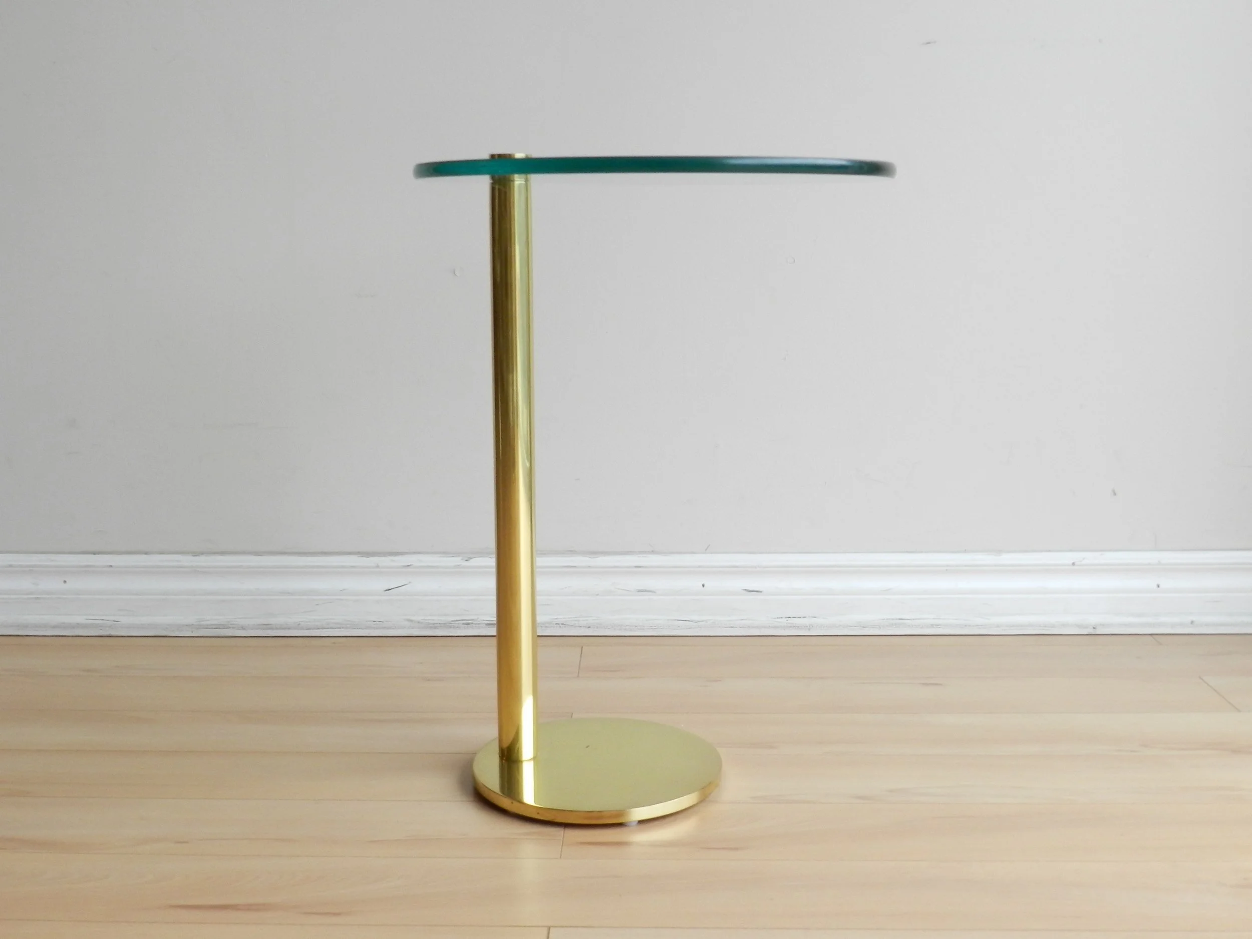 Post modern side table in brass with cantilevered glass top attributed to Prismatique.  Canada, 1980s.