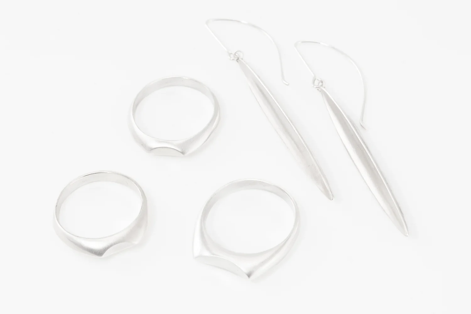 Minimal organic shapes in silver with a luminous matte finish and burnished edges. All full of potential.