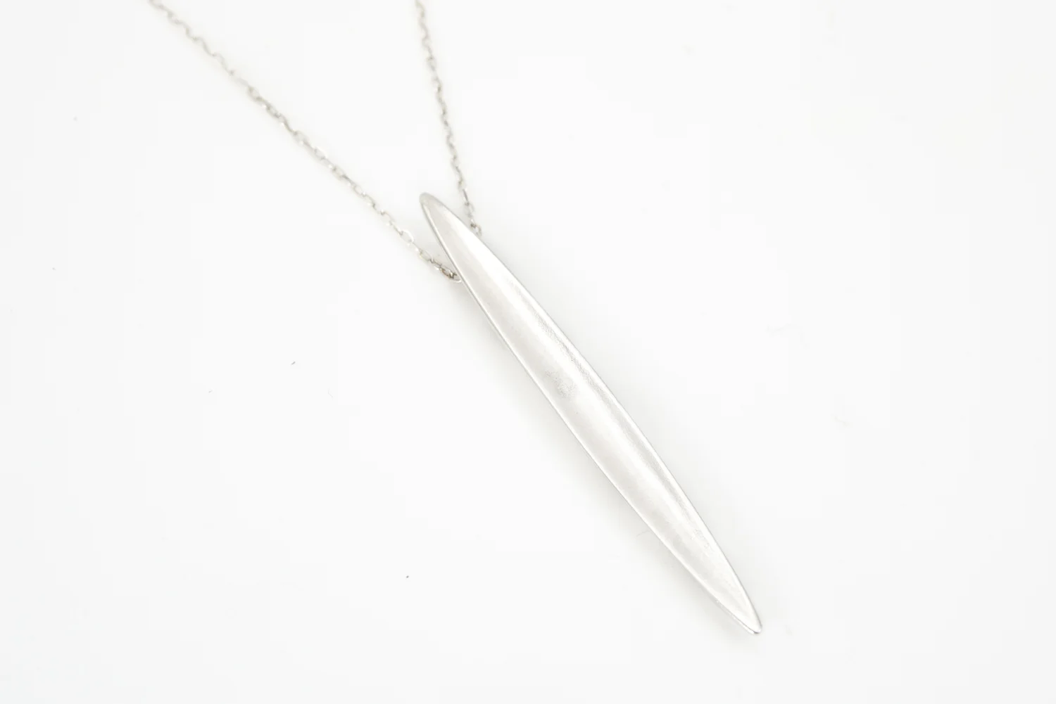 Delicate concave sterling pendant on a silver chain with lobster clasp