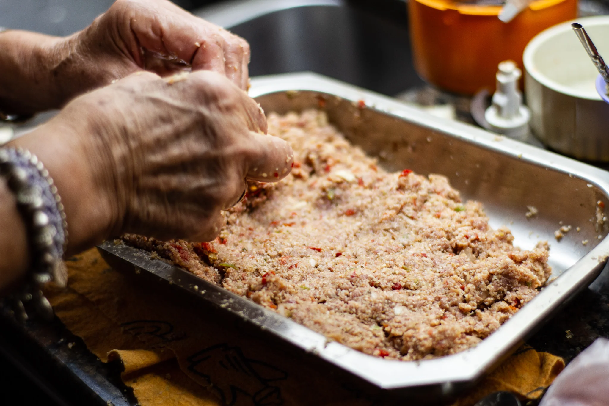 Aida setting kibbi mix into baking dish.