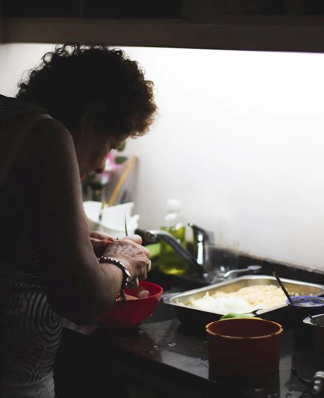 Aida chopping vegetables at her kitchen counter.