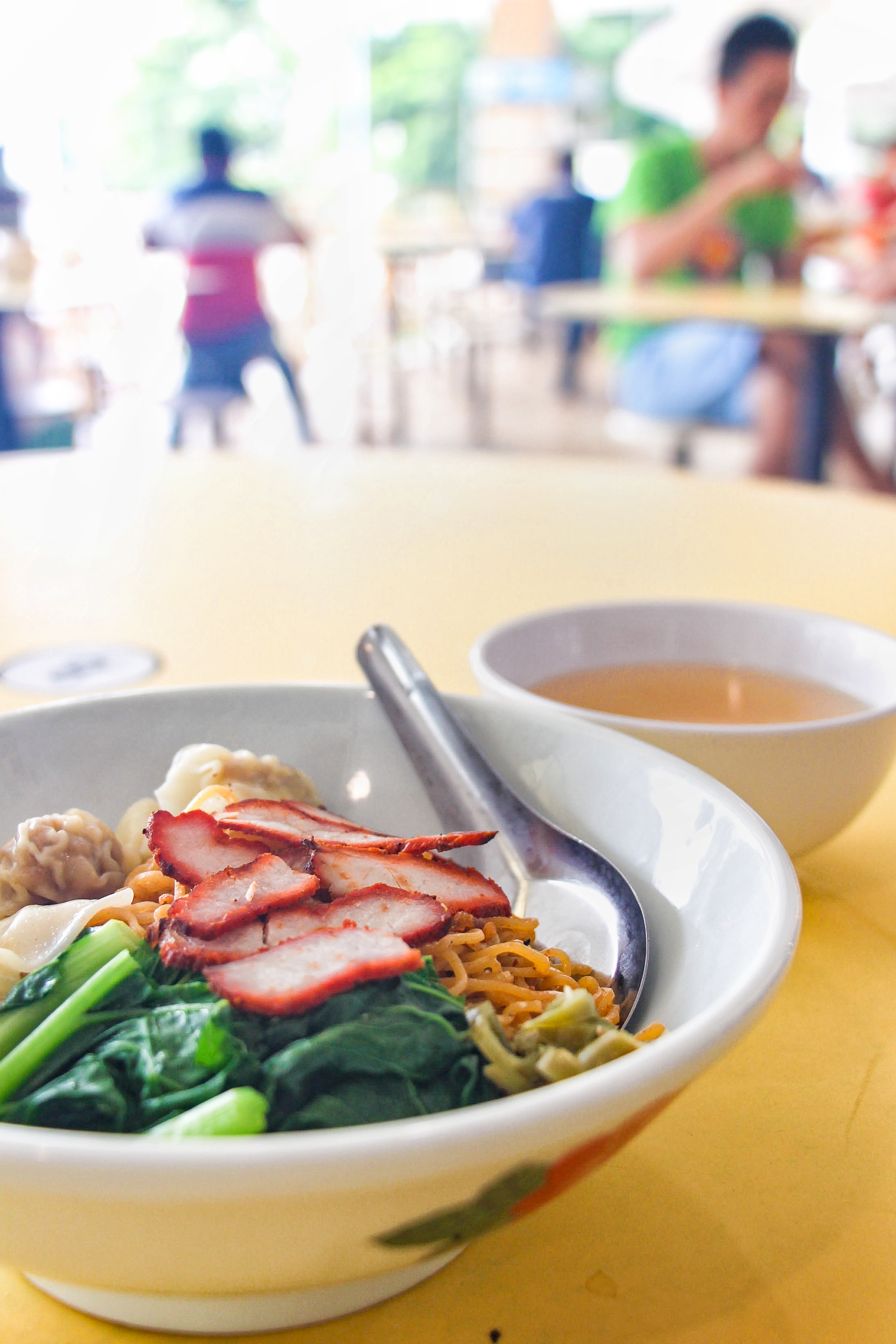 A Cho Kee Noodle dish: Wonton Mee noodles with bok choy, wonton dumplings, char siu pork shavings and a broth side.