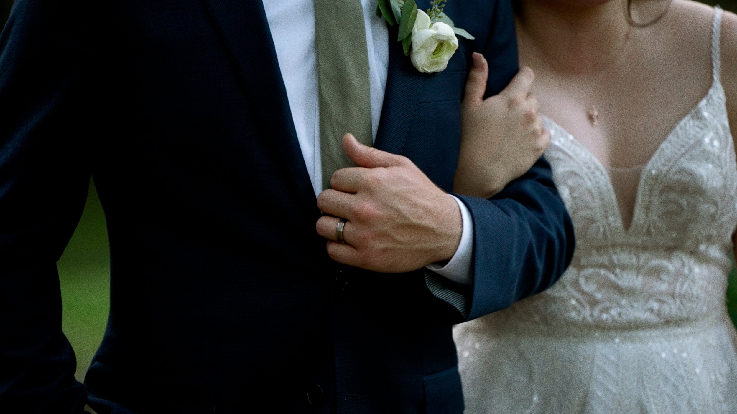 bride and groom walking hand in hand closeup on hands