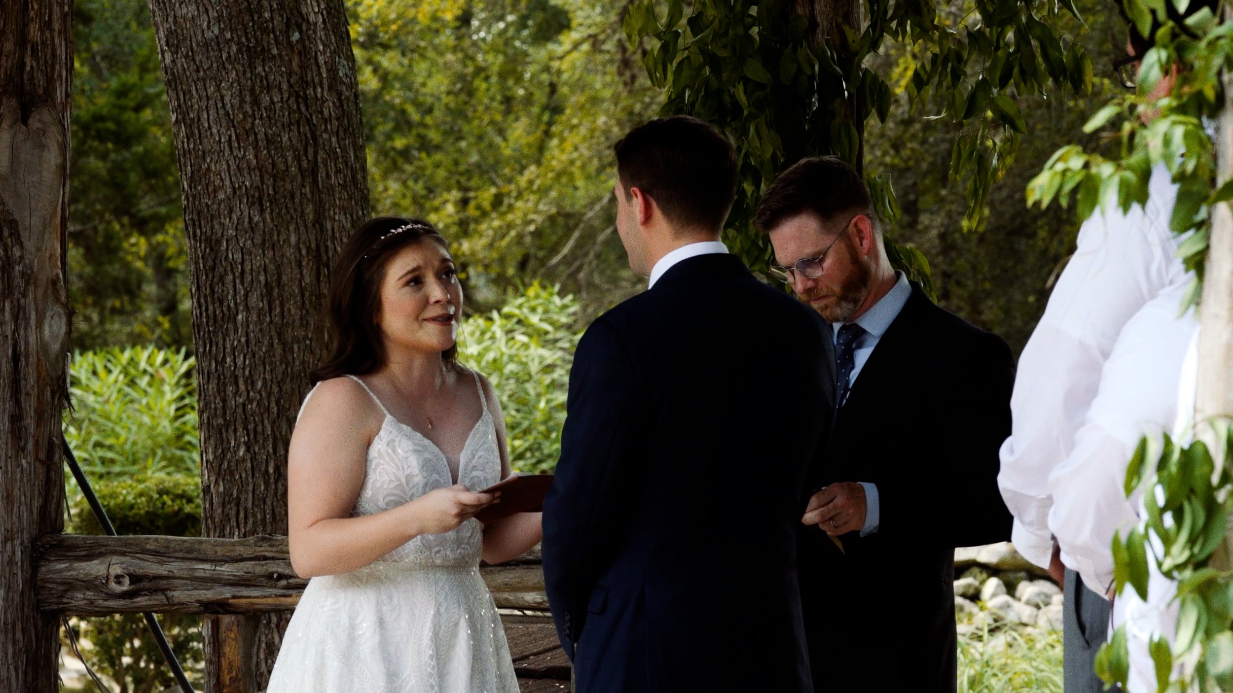 bride reads vows to groom during wedding ceremony at altar