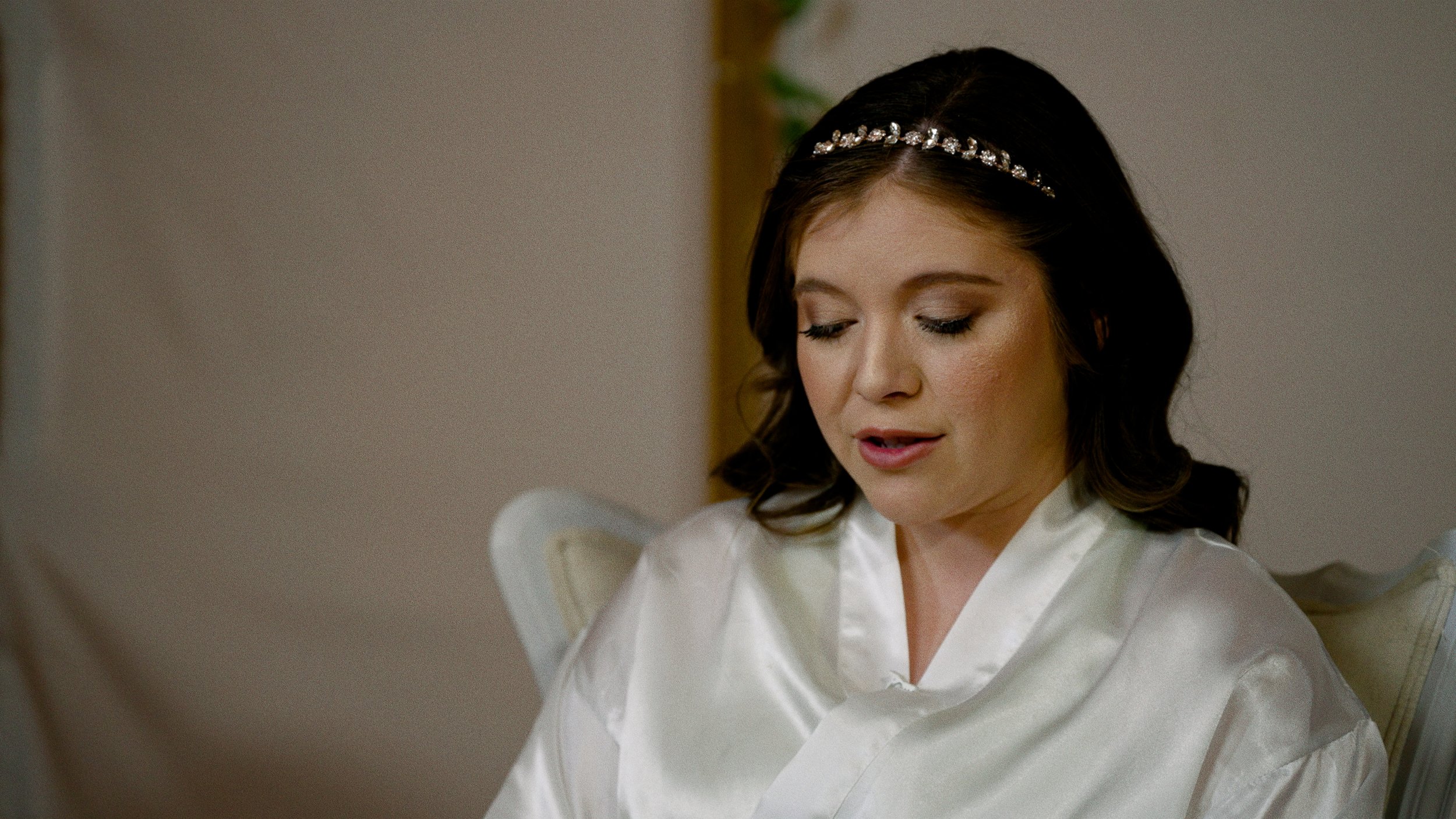 bride reading letter with makeup