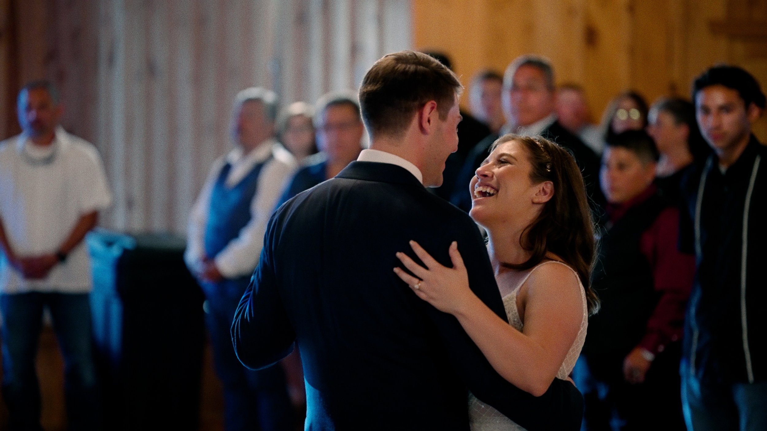 bride smiles at groom during first dance