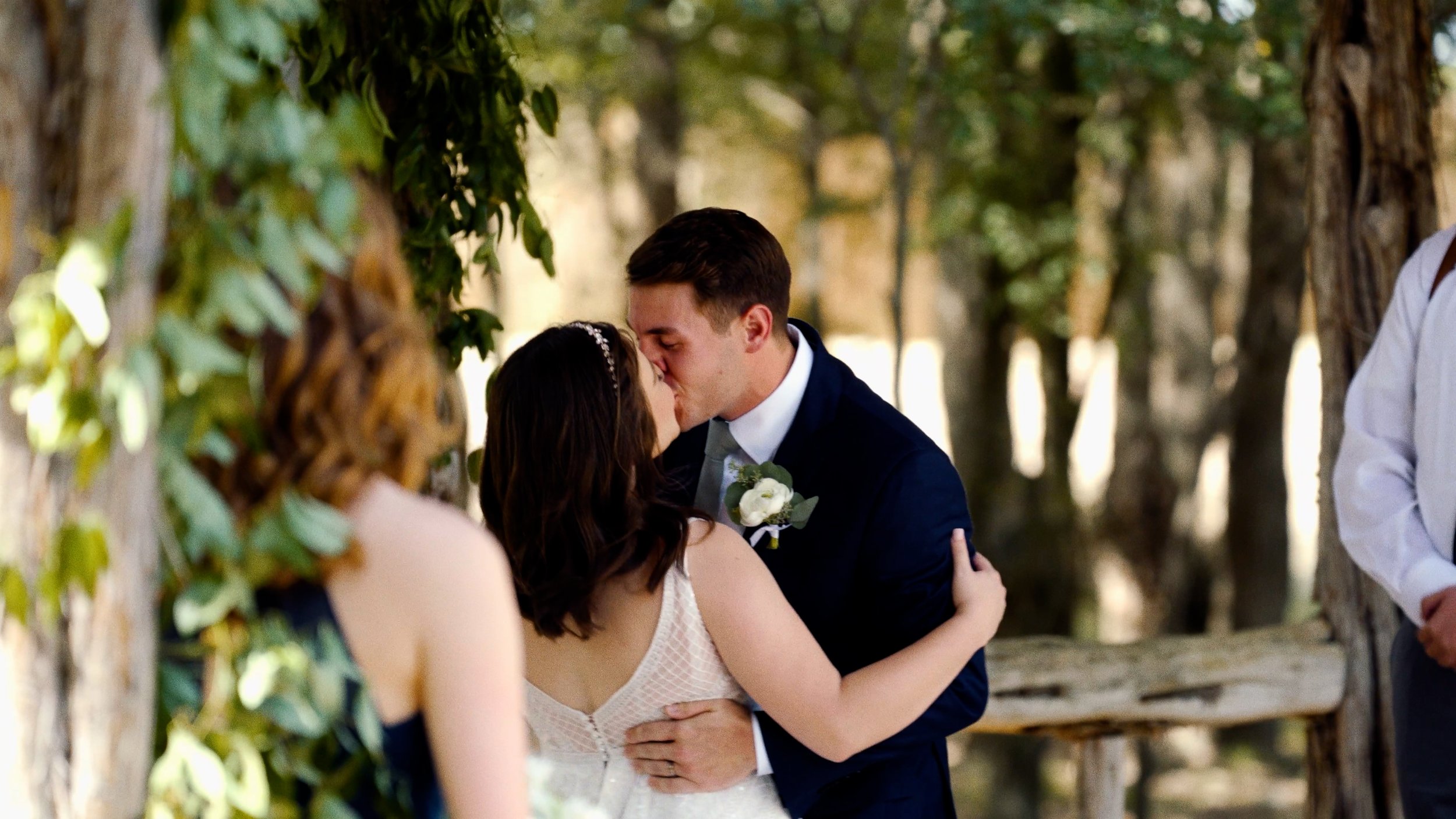 groom kisses bride during ceremony first kiss