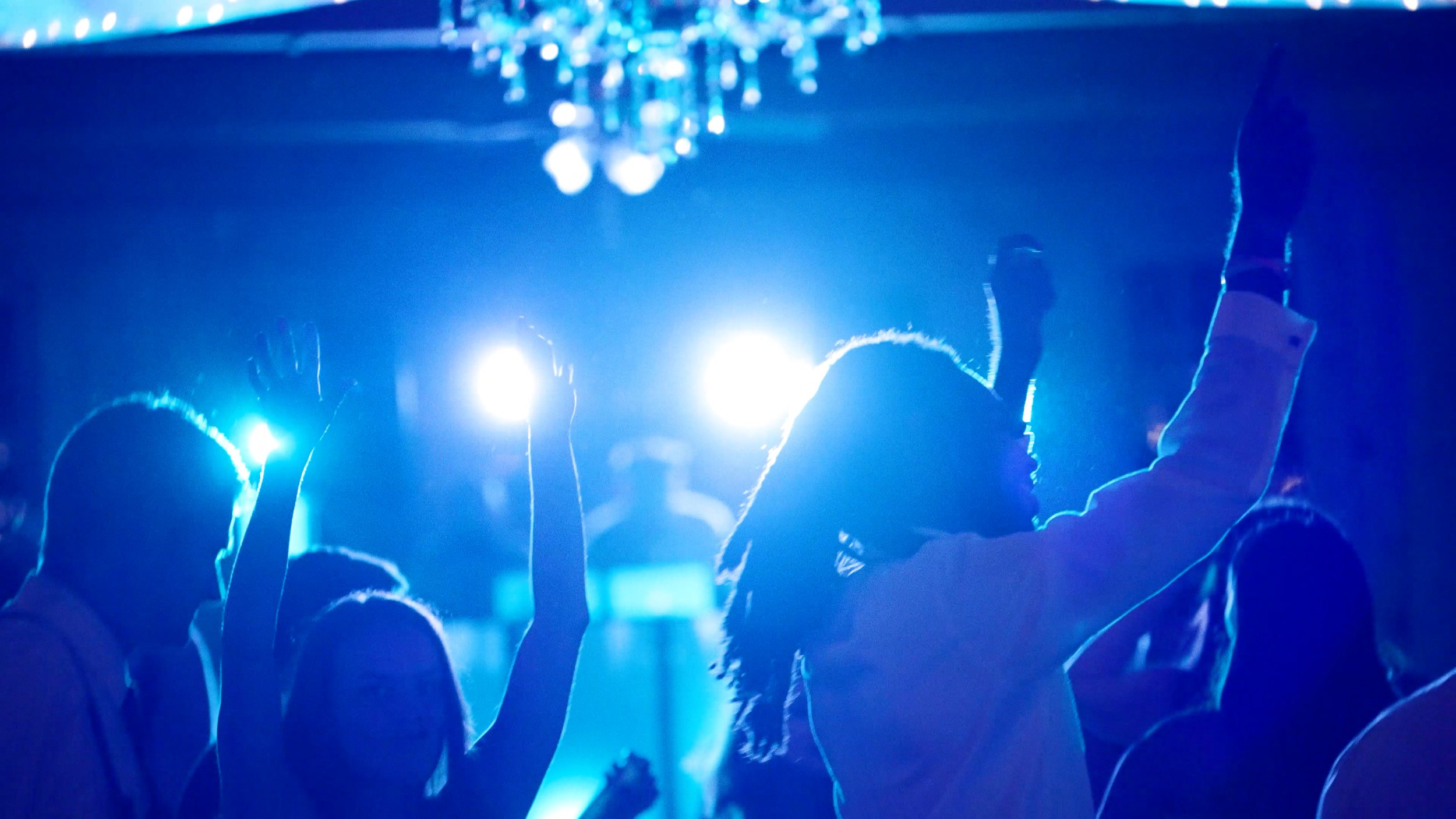 hands raised dancing DJ lights during wedding reception