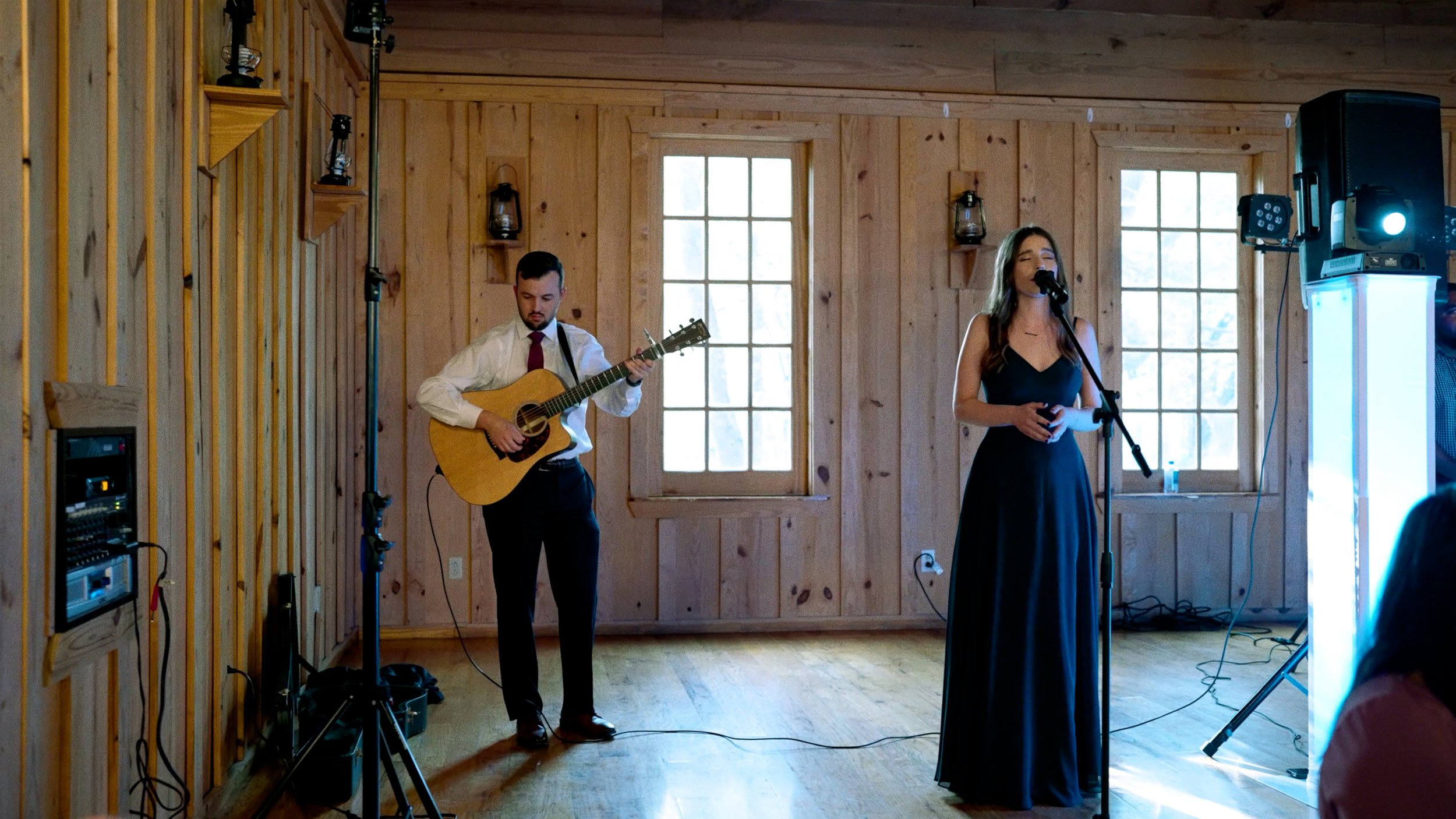 maid of honor sings first dance song for bride and groom on stage