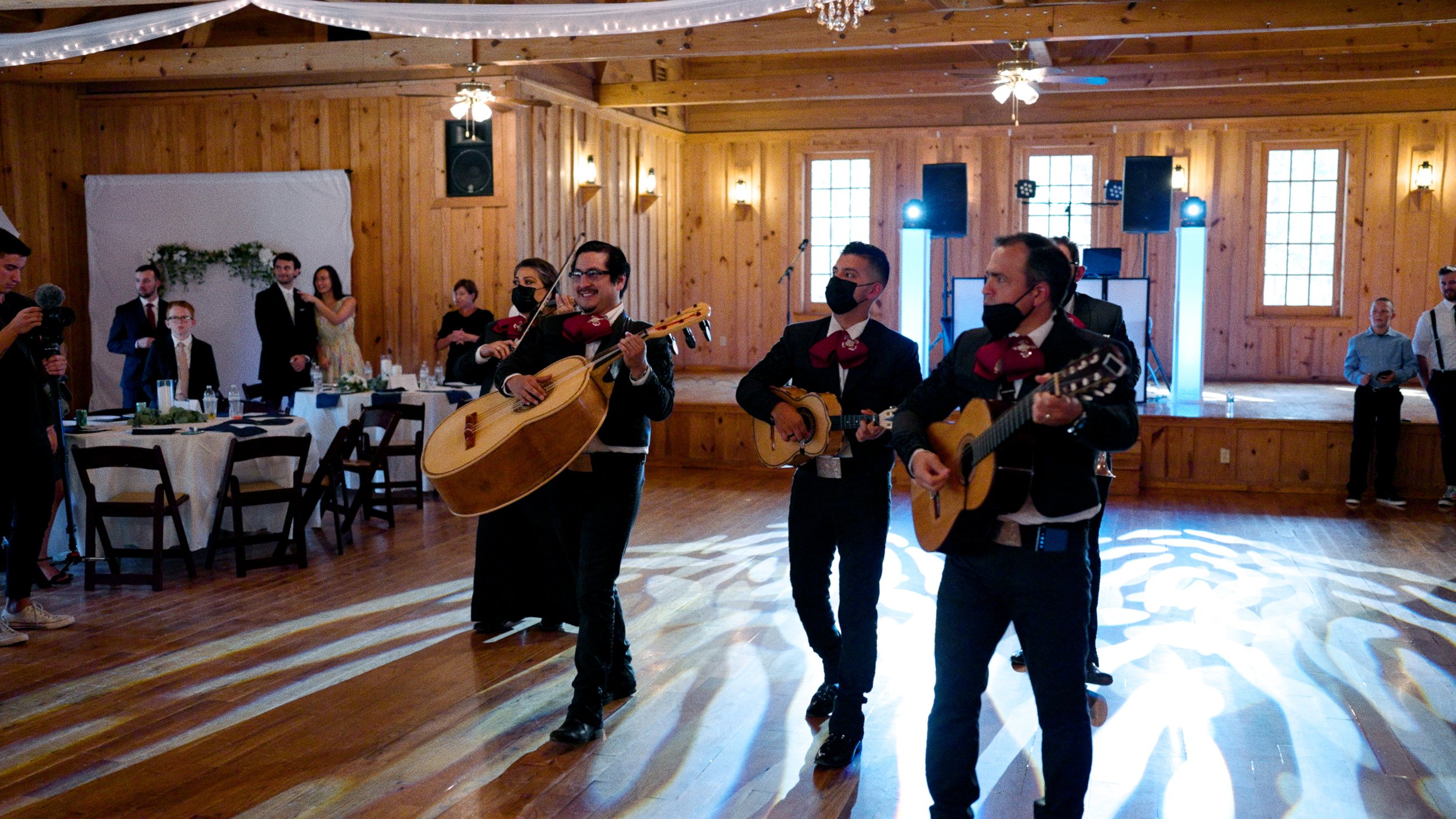 mariachi band playing at dinner inside reception