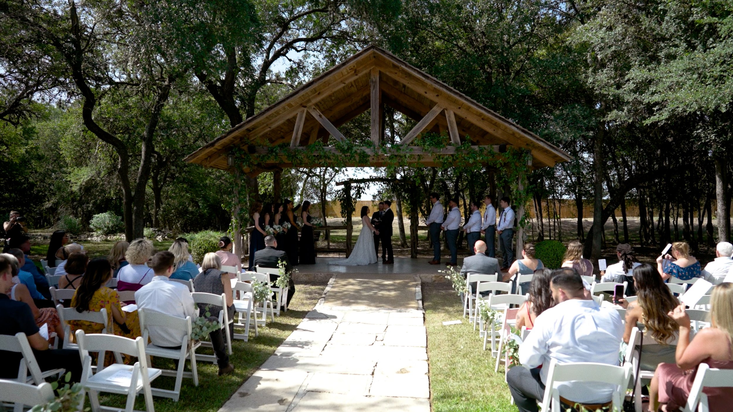 wide shot of wedding ceremony altar bride and groom hold hands
