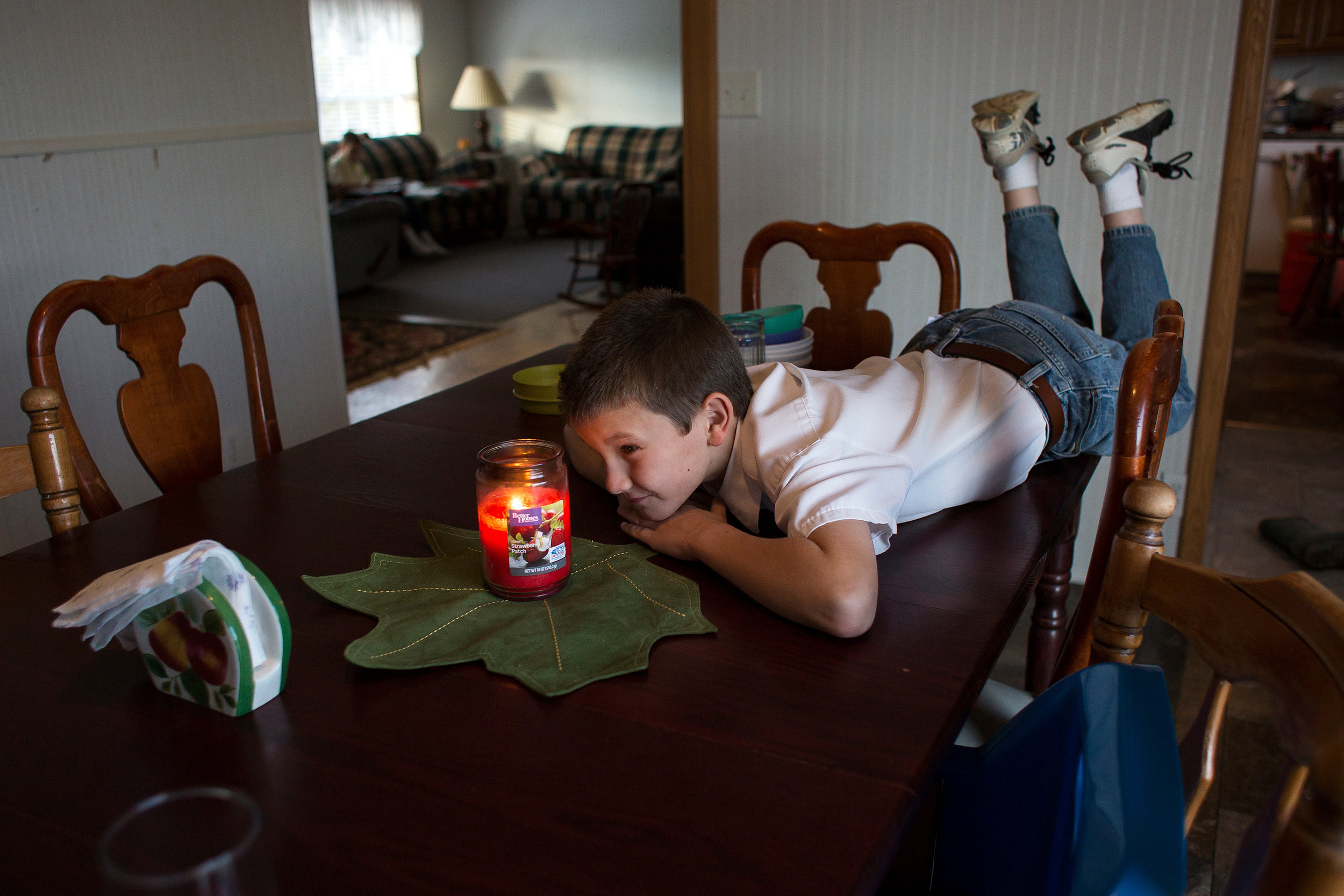 Darius watched a candle burn before setting the dinner table Oct. 31.
