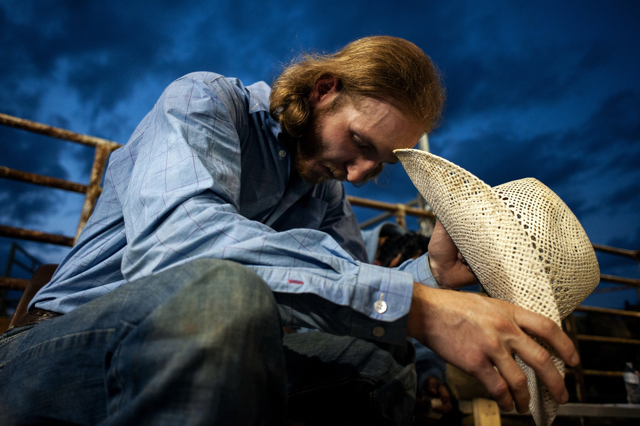  Gray Essary, of Somerville, Tenn., bows his head in prayer before his bull ride. The 23-year-old, who makes a living traveling “coast to coast, border to border” for rodeos, said prayer is a way to help clear your head and help him focus before the 