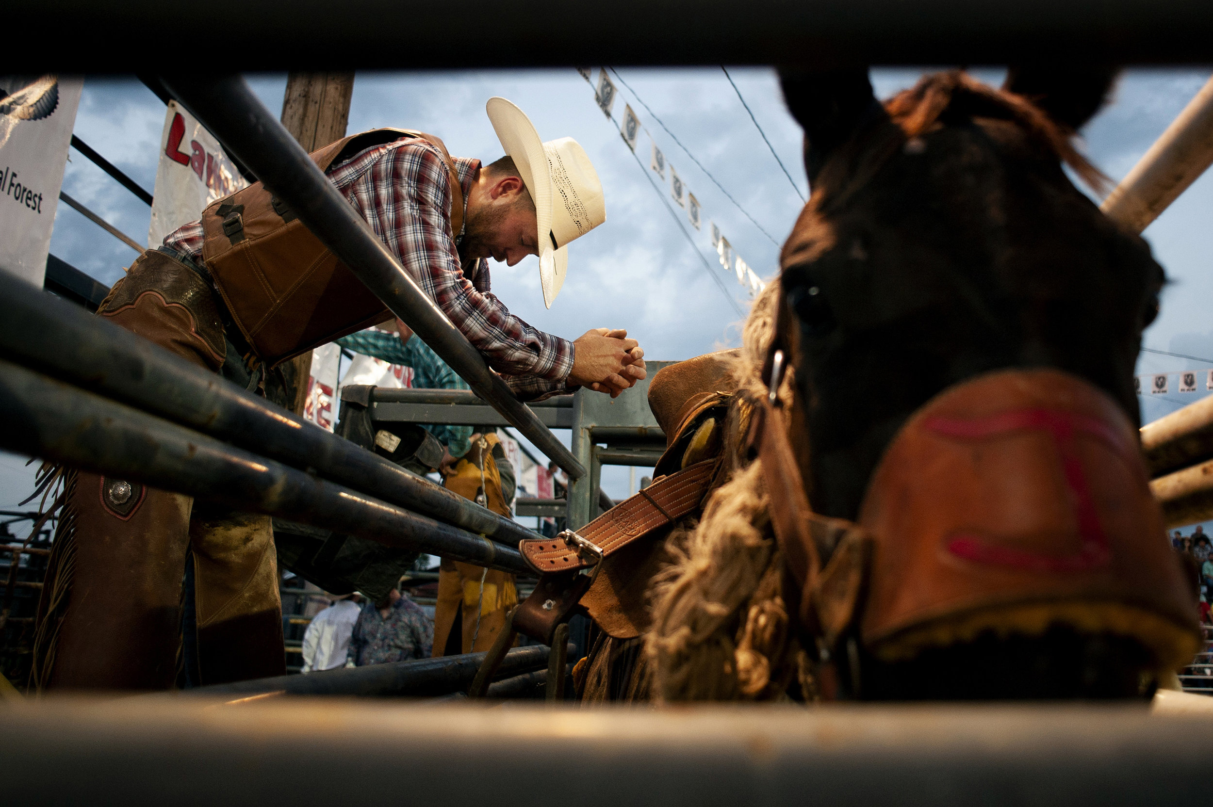  Brauer takes a moment to collect himself before his saddle bronc competition. Brauer, who shoes horses for a living and makes part of his income through rodeo, prays at competition and said religion is everything to him. “I pray to keep my family sa