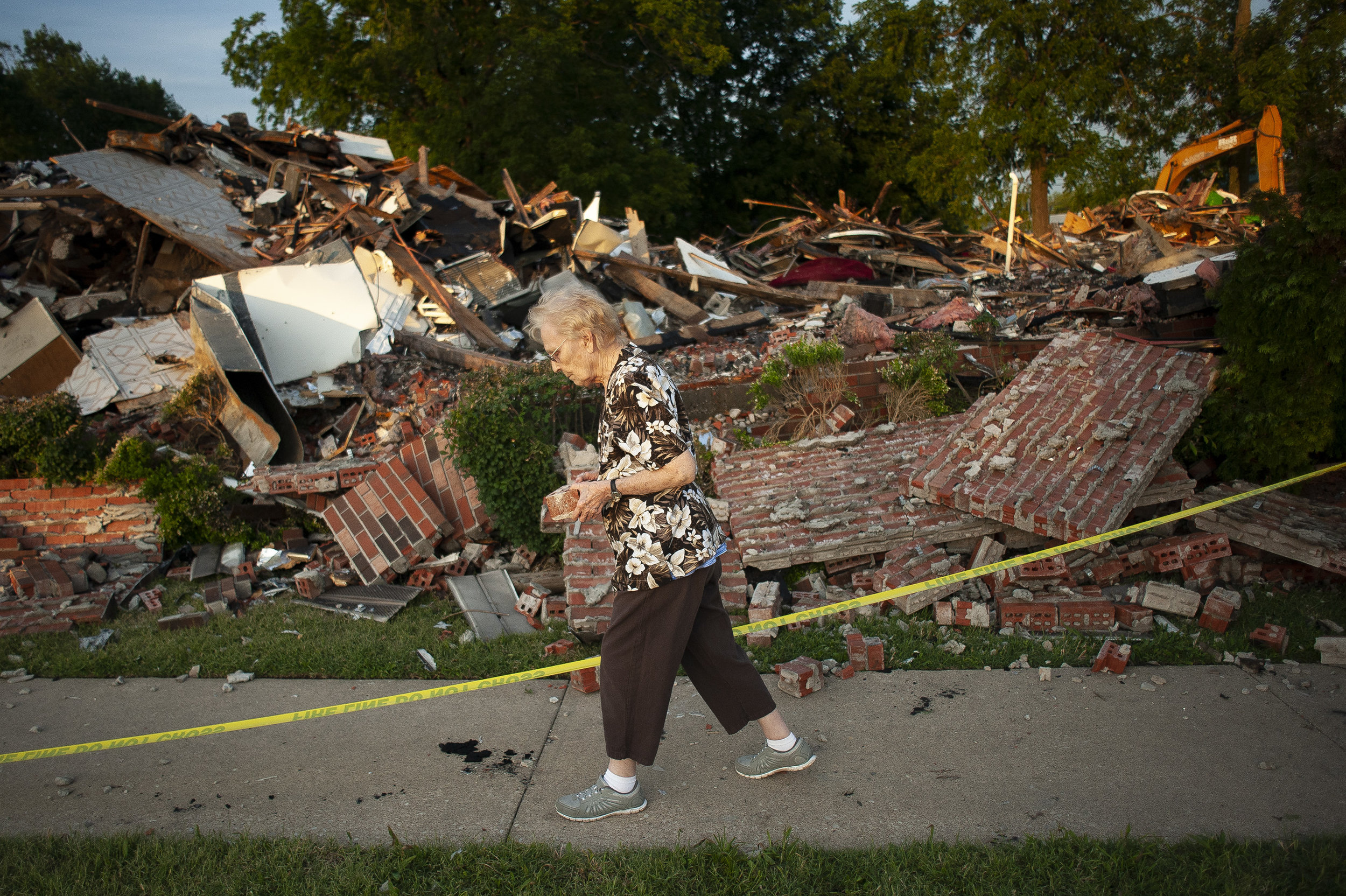 Arleen Tipsword, who at age 90 believes herself to be the oldest member of Cornerstone Wesleyan Church, takes a brick as a souvenir from the remains of the church June 22 at 210 E. Outer Road in Scott City, Missouri. "It's heartbreaking," Tipsword s