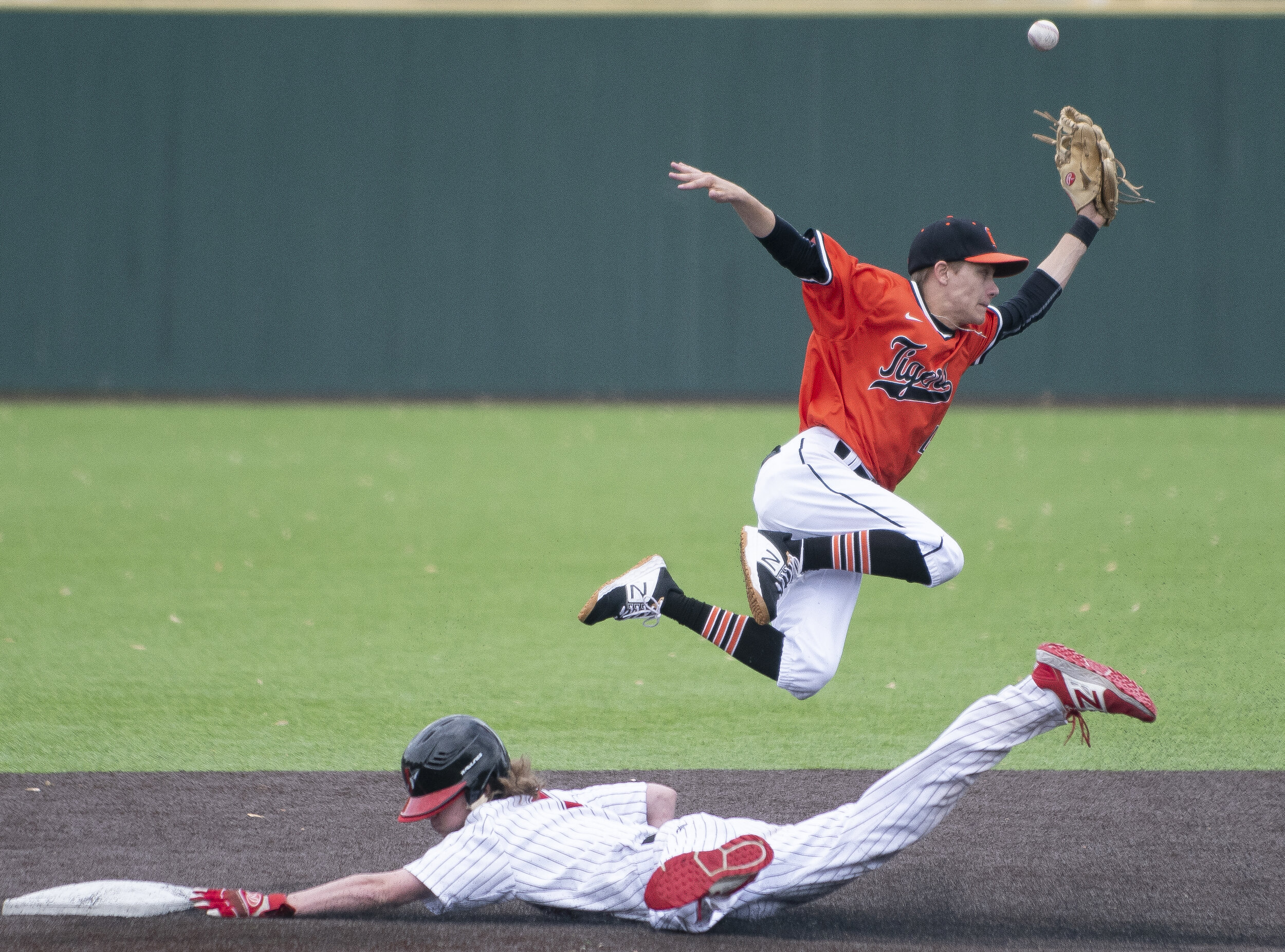  Cape Central's Luke Laramore (4) attempts to grab the ball as Jackson's Kalin Ellis (1) goes to second during Jackson's 15-0 win over Cape Central in the SEMO Conference semifinals April 27 at Capaha Field in Cape Girardeau, Missouri.  