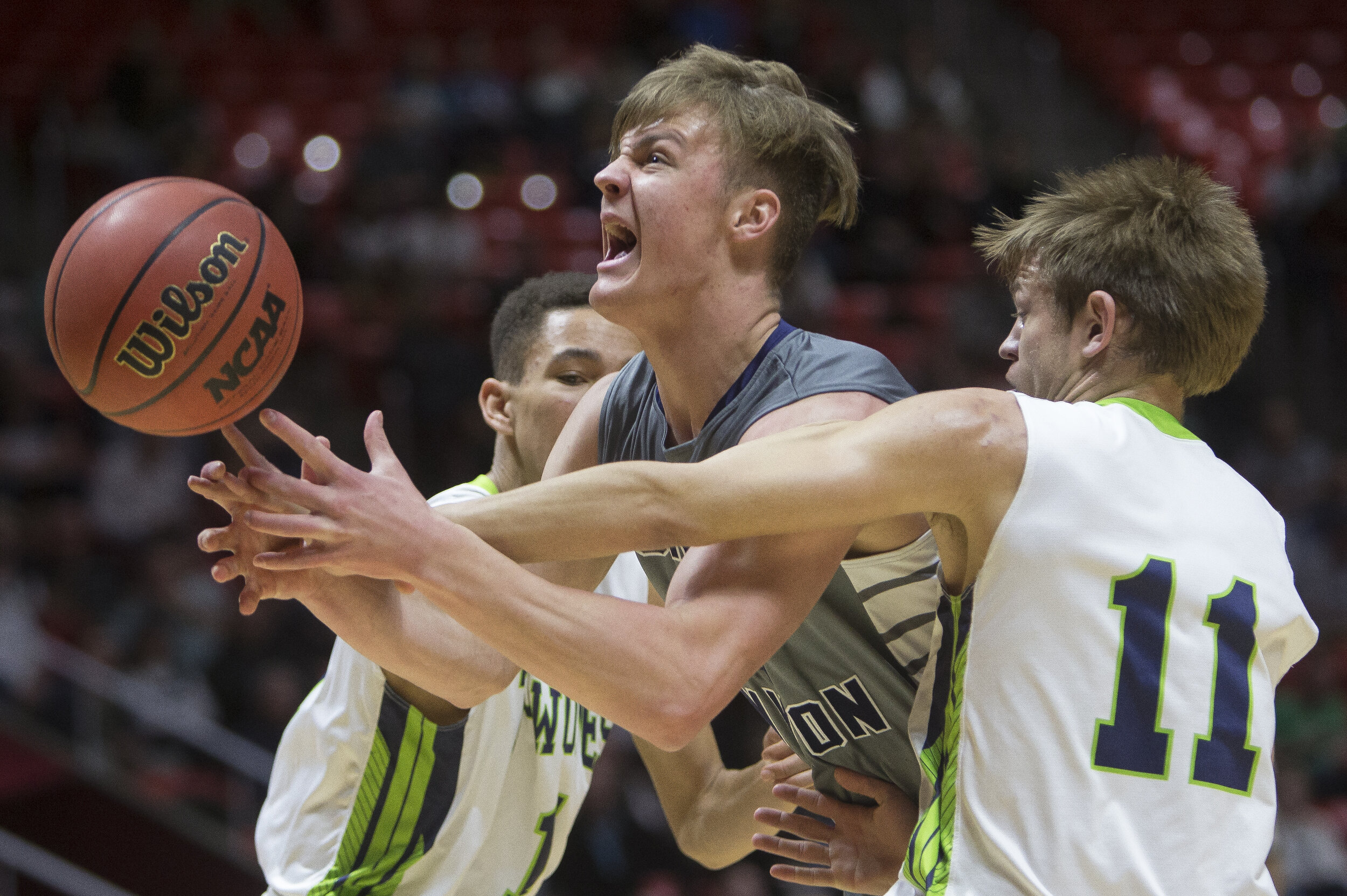  Corner Canyon's Gabe Toombs attempts a shot while guarded by Timpanogos' Jacob Maddox (11) and Robert Christensen (1) during Corner Canyon's 65-52 victory against the Timpanogos Timberwolves in the Class 5A state semifinals March 2 at the Jon M. Hun