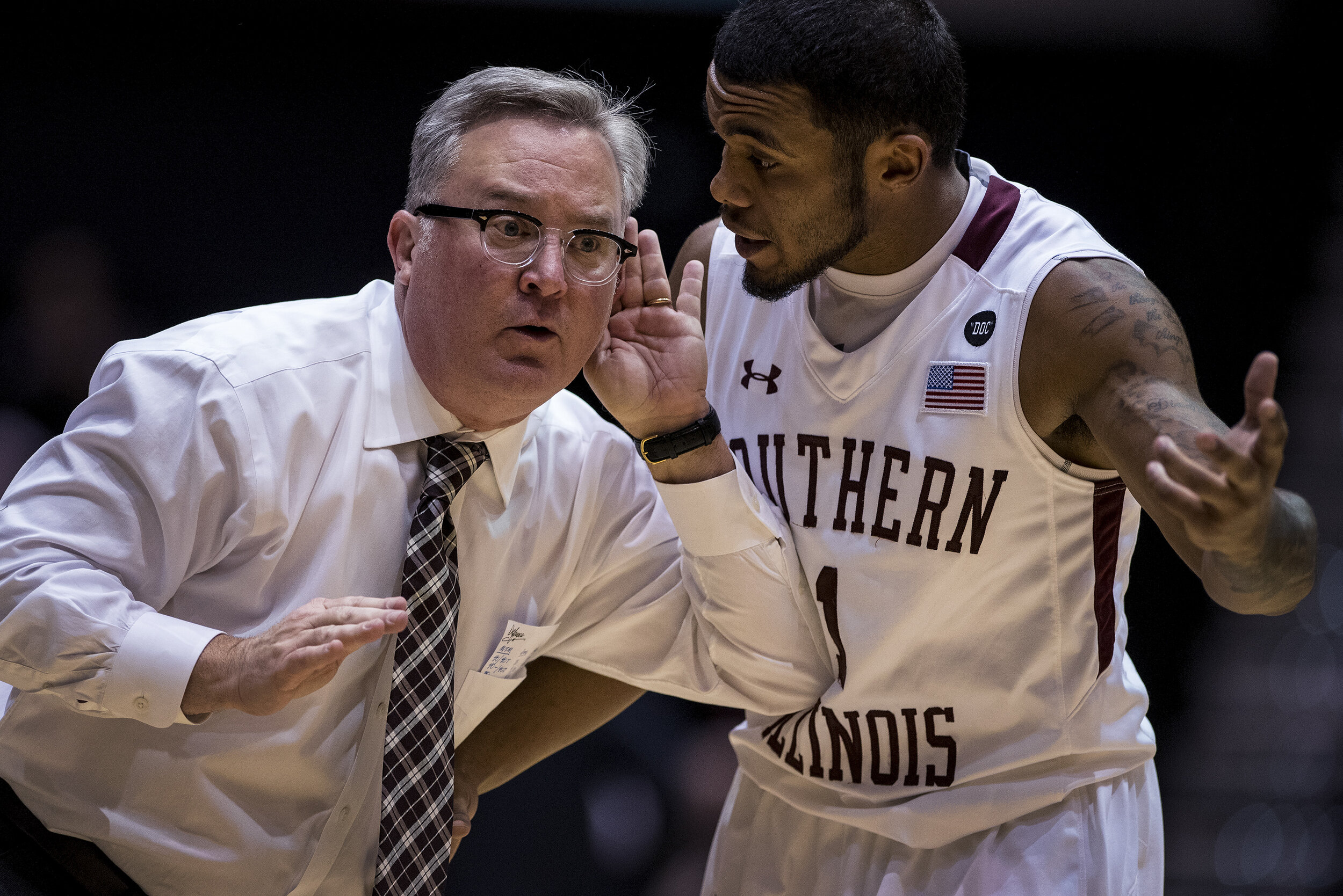  Southern Illinois coach Barry Hinson listens to senior guard Mike Rodriguez during SIU's 78-70 victory against UT-Martin on Dec. 22 at SIU Arena in Carbondale, Illinois. 