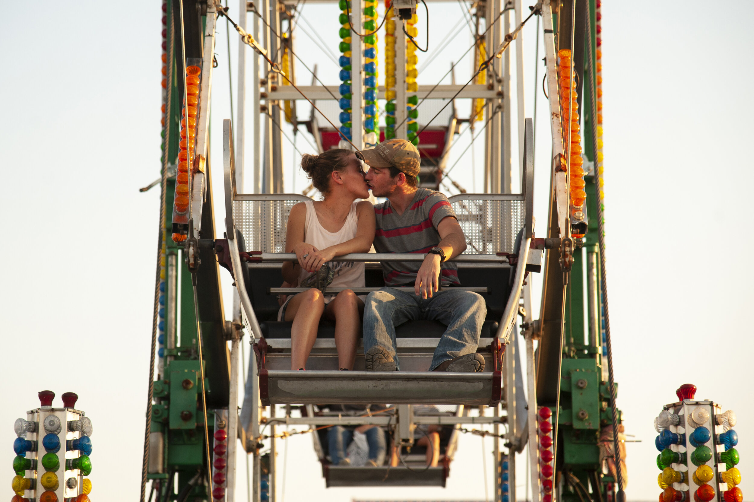  Kaitlyn Davenport and Jacob Grimes, both of Brookland, share a kiss while making the final decent on a carnival ride Sept. 19 at the Northeast Arkansas District Fair in Jonesboro, Arkansas. The pair said they have been dating for six months.  