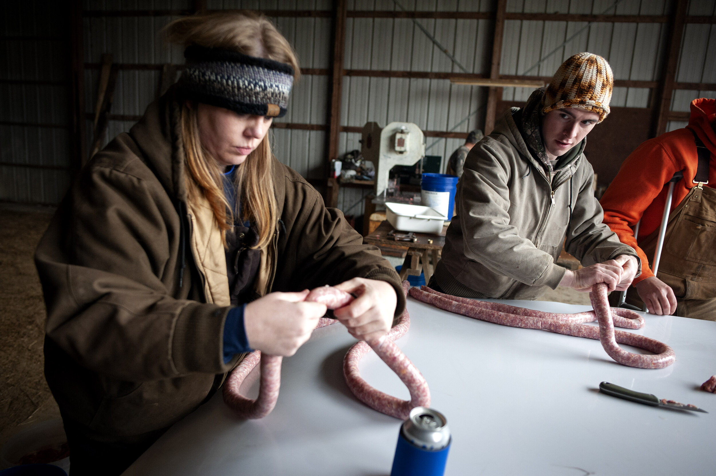  Terina Dillahay of Perryville, Missouri, (left) and Austin Hotop work with hog meat shortly after it was put into sausage casing.  