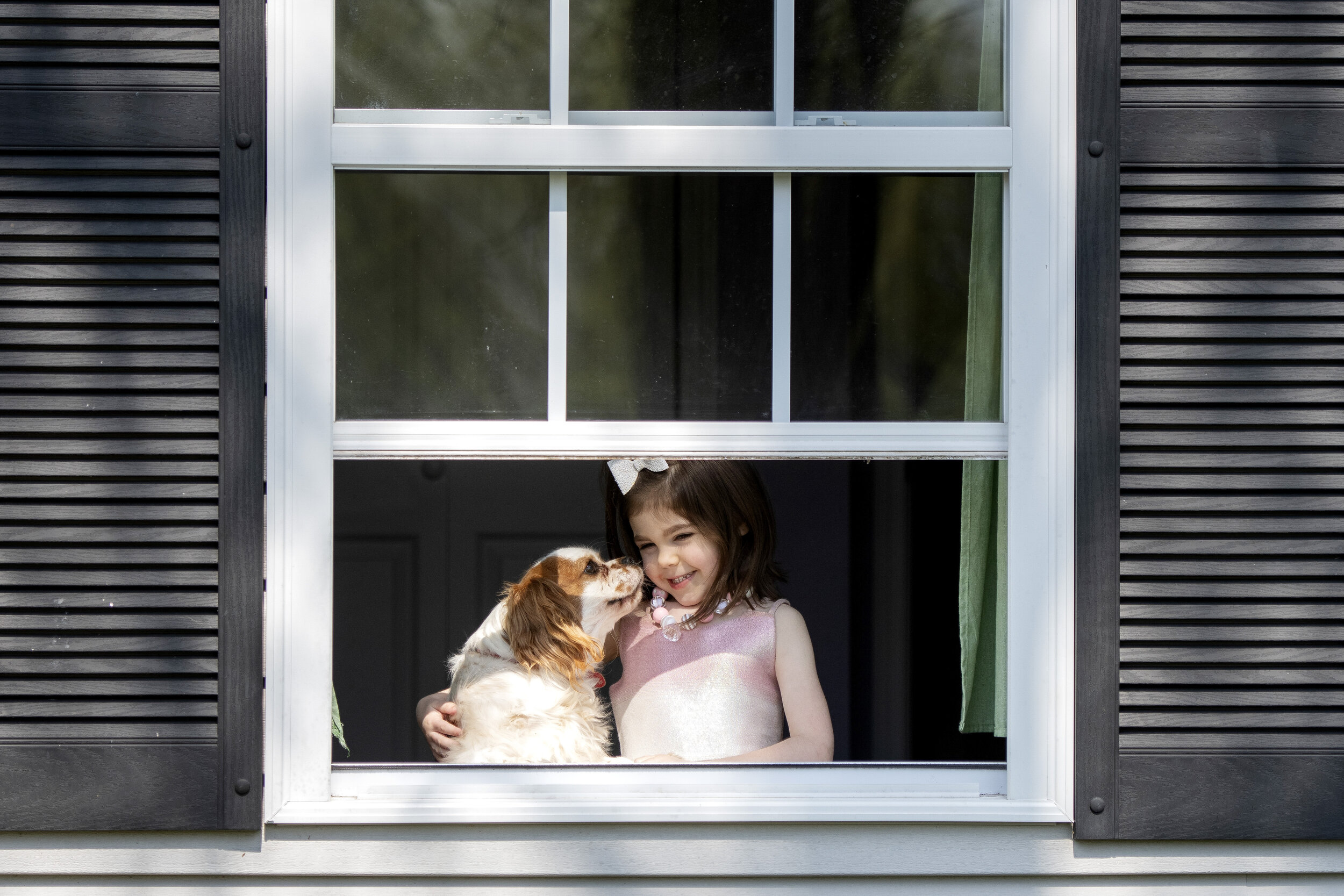  Annistyn “Anni” Bridges, 4, shares a moment with the dog, Nash, while taking a portrait Wednesday, April 8, 2020, at their Cape Girardeau home. Heather Bridges, originally of Benton, Missouri, and now Cape Girardeau, has been working full time while
