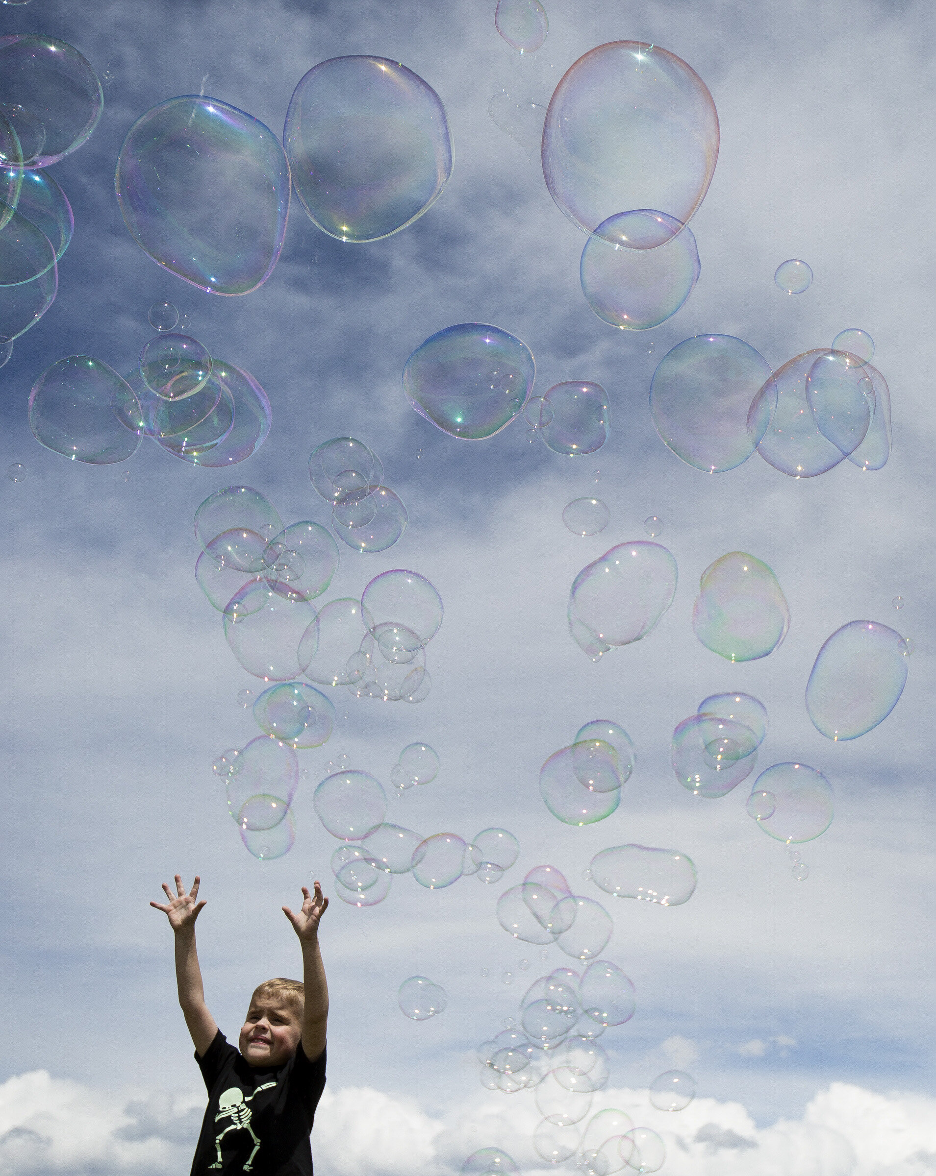  Dane Cliften, of Layton, 5, holds his arms in the air as bubbles float over the lawn of the Utah State Capitol on May 13 in Salt Lake City, Utah. “It doesn’t matter what country you’re from, we all love bubbles,” said Abraham Roe, of Salt Lake City,