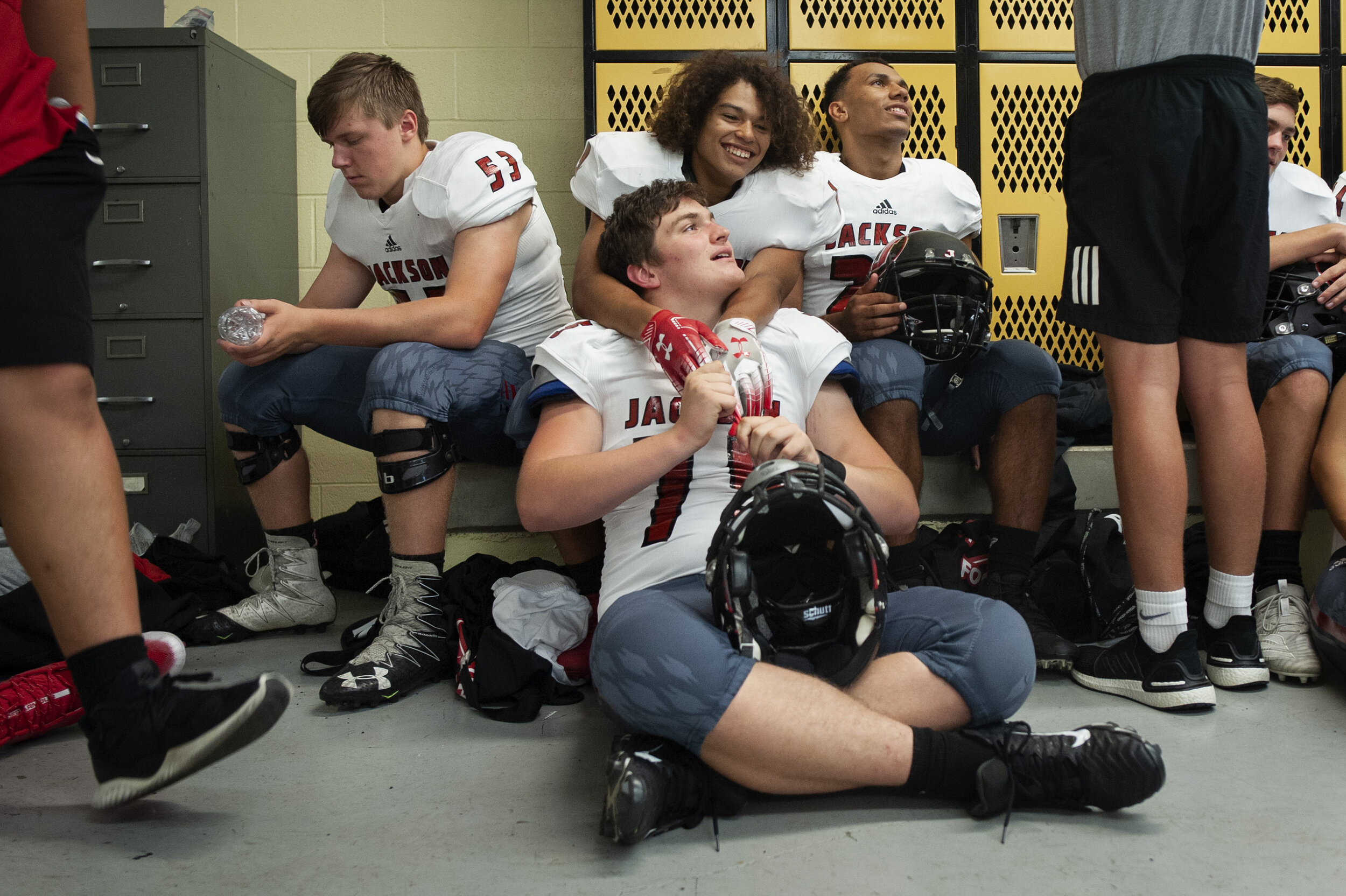  Top row from left: Jackson's Nathan Harrison (53), Joshua Wehrenberg (19) and Javin Hitchcock (27) wait for the start of the game with Mark Brakhane (75), bottom center, before the Jackson Indians' 35-14 victory over Farmington on Friday, Oct. 4, 20