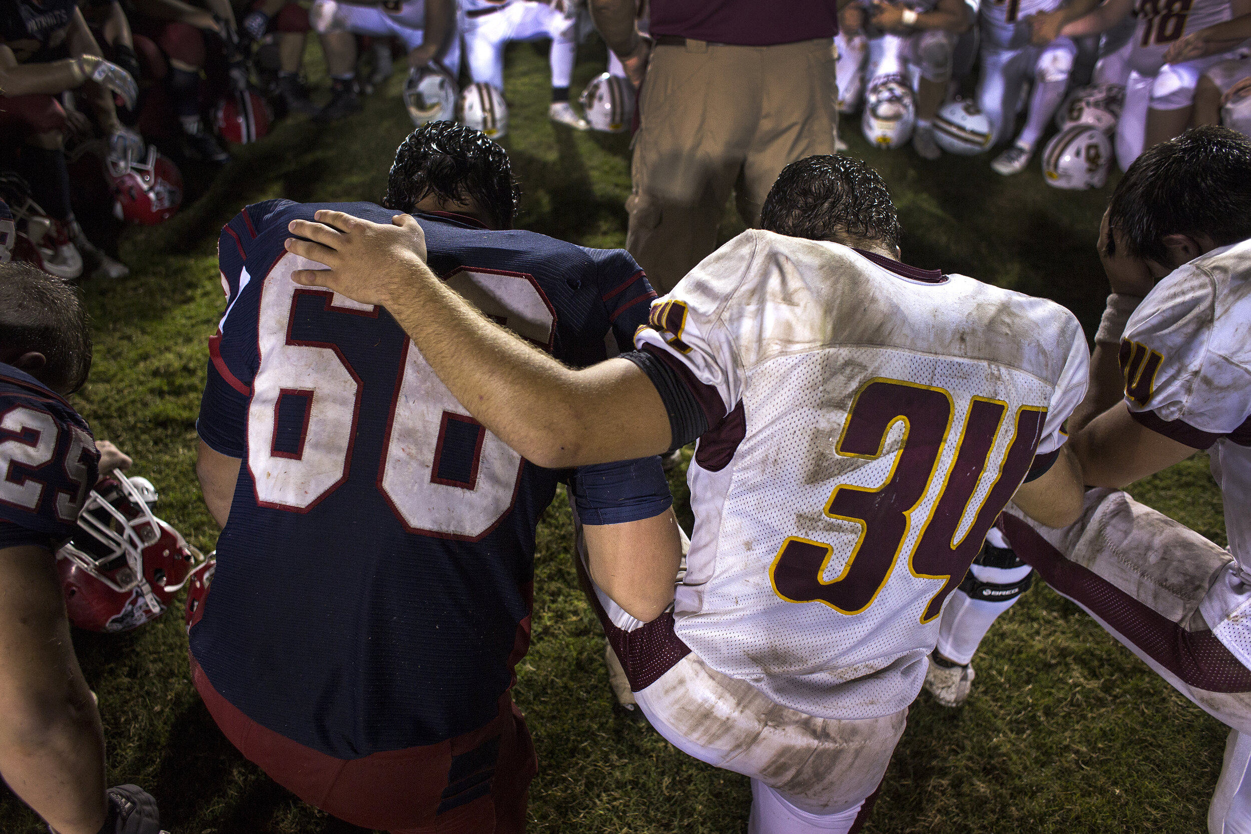  Heritage Hills’ Spencer Buse and Gibson Southern’s Dylan Stefanich said a prayer with other Patriots and Titans during a group prayer following Heritage Hills’ 48-7 loss to the Gibson Southern on Sept. 22 in Lincoln City, Indiana.  