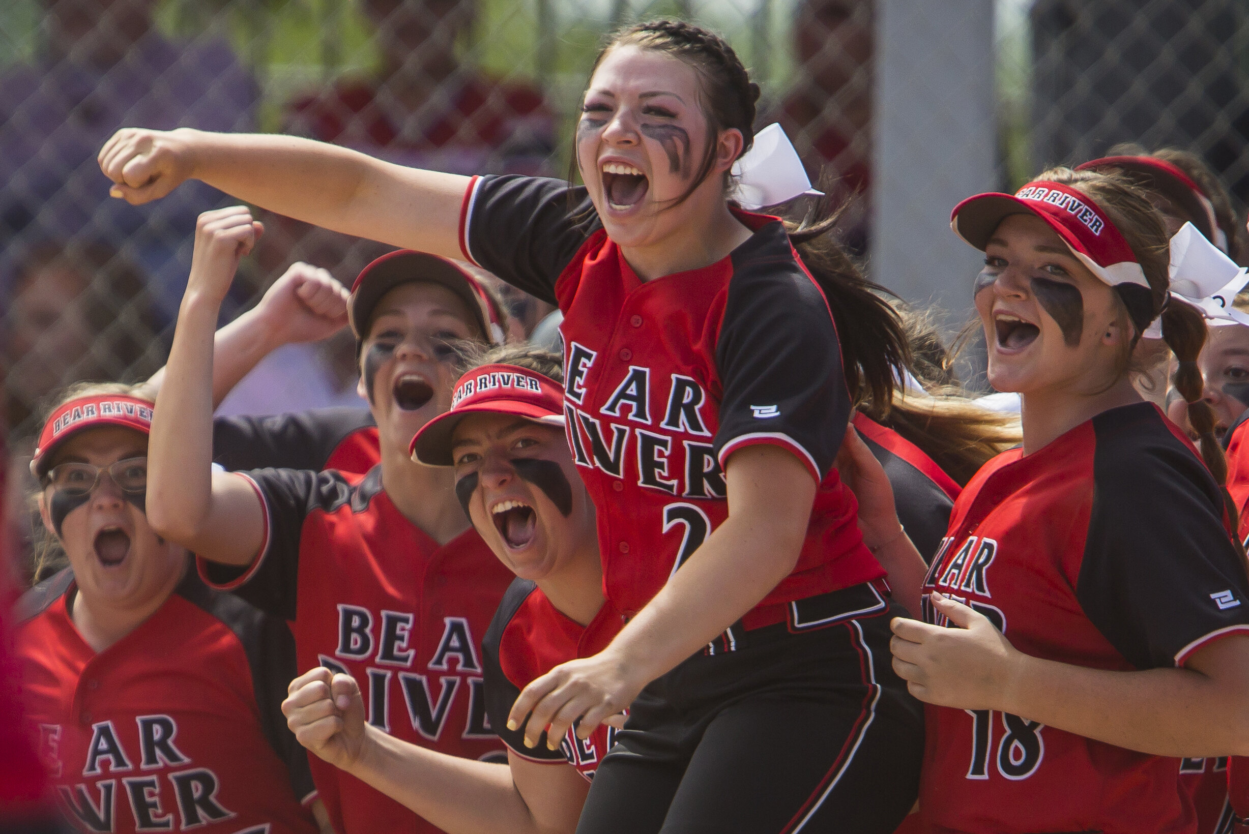 Bear River's Josie Larkin (21), center, cheers with fellow Bears as teammate Taylor Fox (20) makes her way toward home plate near the conclusion of the Bear River Bears' 5-4 win over the Spanish Fork Mighty Dons in the Class 4A state championship at