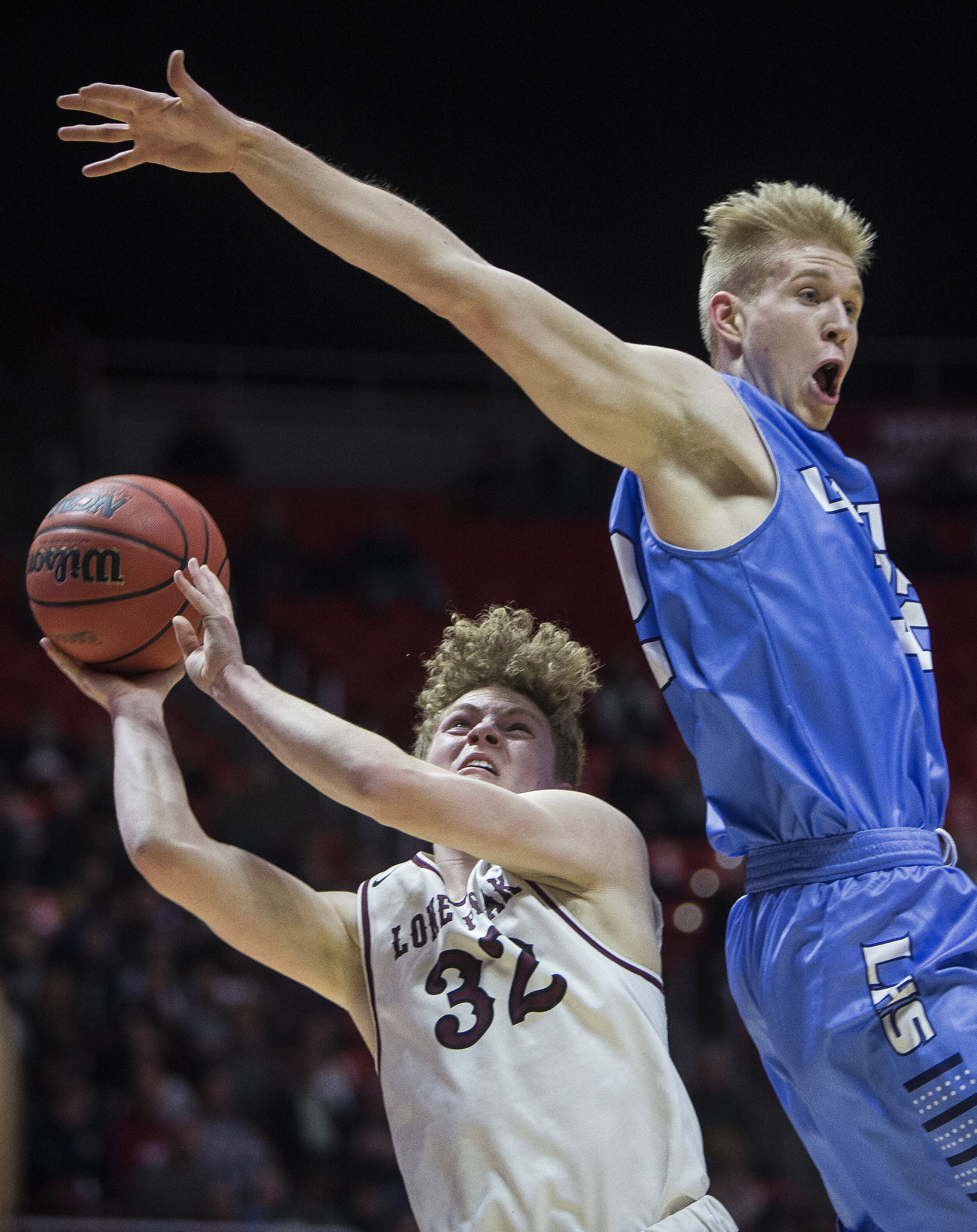  Lone Peak's Taylor Madson puts up a shot while guarded by Layton's Skyler Turner during the Lone Peak Knights' and Layton Lancers' matchup in the Class 6A state semifinals at the Jon M. Huntsman Center on March 2 in Salt Lake City.  