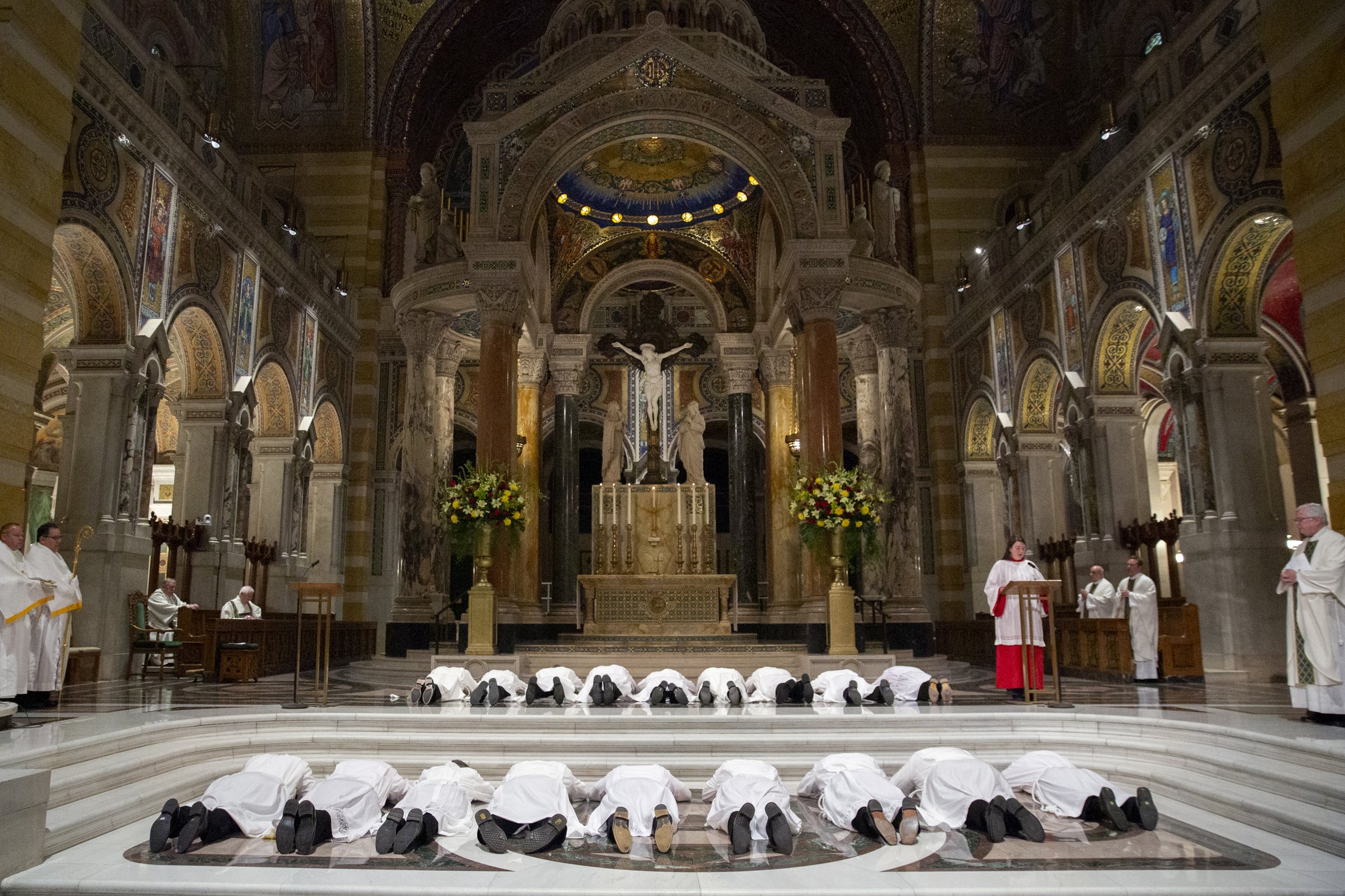  Eighteen permanent deacon ordination candidates lay prostrate during the Litany of Supplication during the Rite of Ordination of Deacons on June 4 at the Cathedral Basilica of Saint Louis in St. Louis, Missouri.  