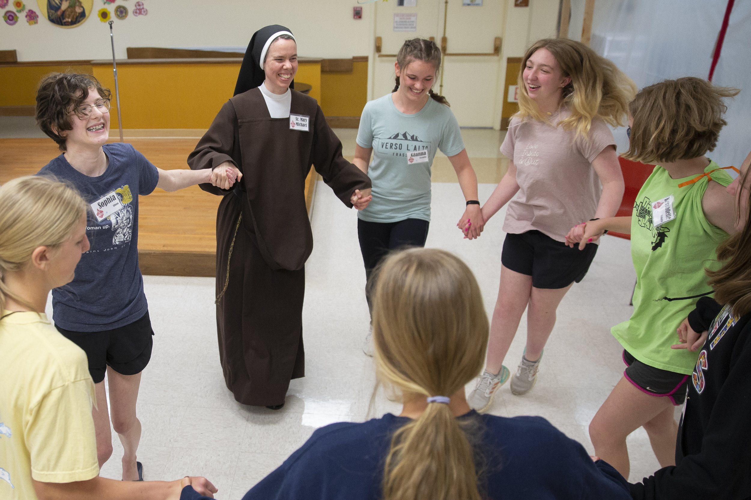  Facing camera from left: Sophia Simon, Sister Mary Michael, Gianna Citrowske and Gia Vorwerk smiled while Irish dancing during Carmelite Day on May 21 at St. Agnes Home in Kirkwood, Missouri. Sister Mary Michael said the purpose of Carmelite Day, wh