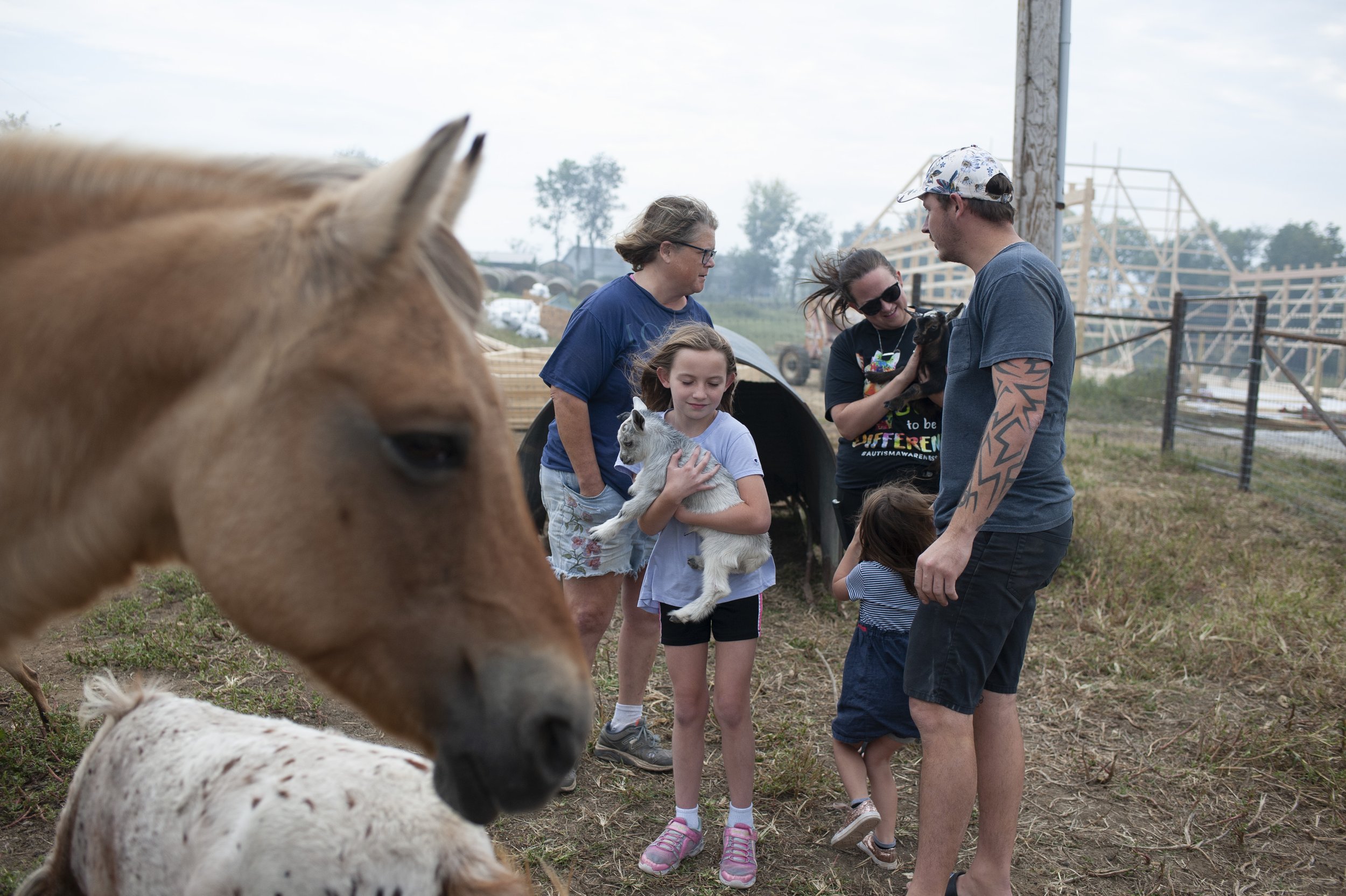  Members of the Pensick family including 8-year-old Rylee (center), 3-year-old Haylee, Liz and Joe meet with Mary about purchasing young goats at her farm. Mary breeds goats and horses. 