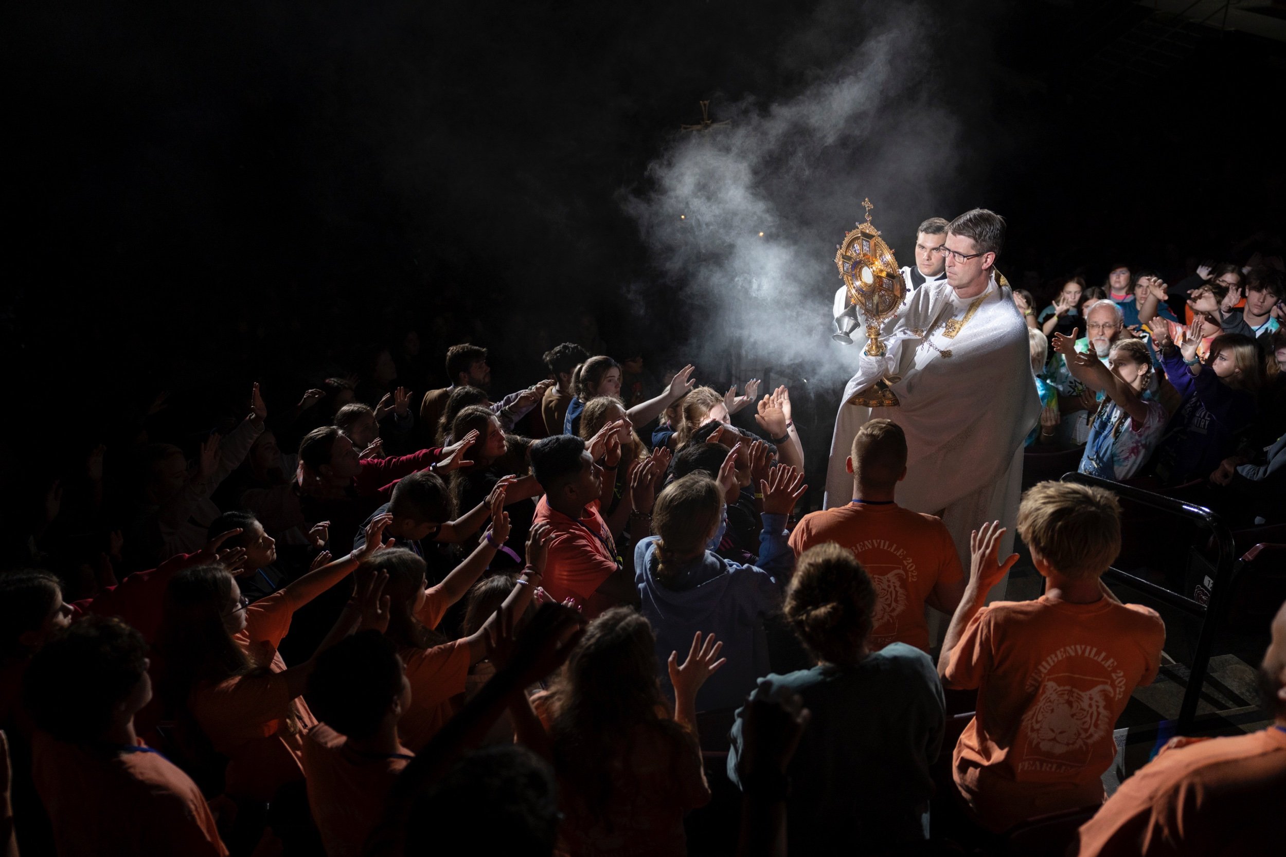  Father Christopher Martin carried the Blessed Sacrament in eucharistic adoration during week two of the Steubenville STL Mid-America youth conference July 16 at the Great Southern Bank Arena in Springfield, Missouri. About 3,300 people attended the 