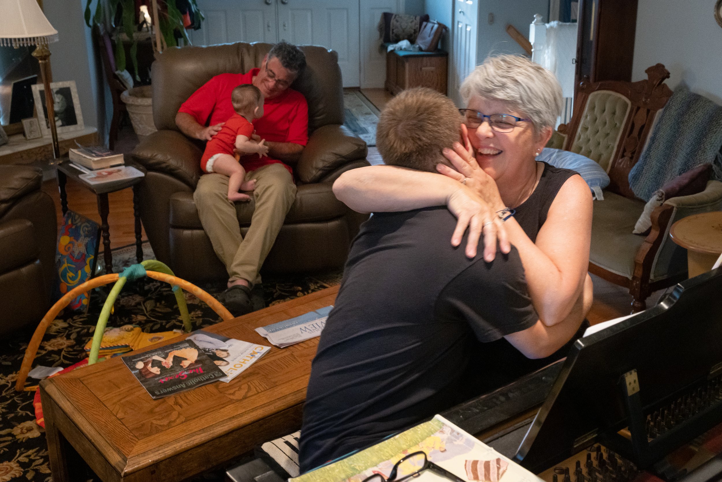  Lori hugged Gabriel after they played a song on the piano near Gabriel's father, Thomas, and his nephew, Ignacio Davila, on June 1 at the Cobb home near St. Charles, Missouri. 