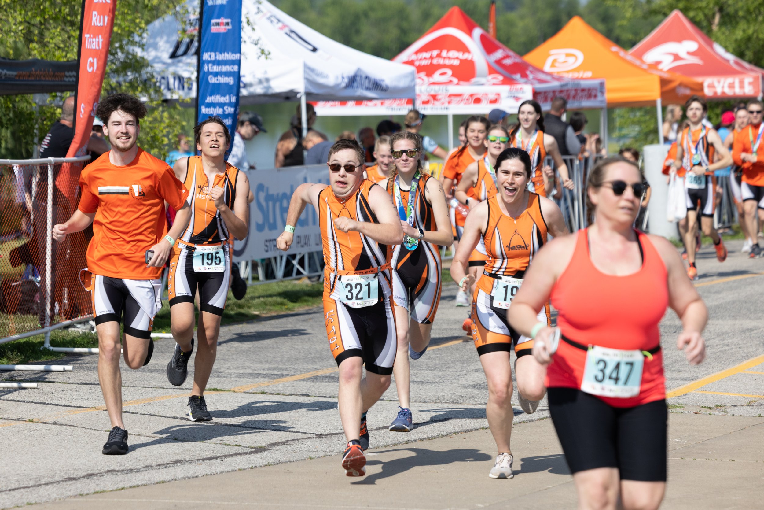  Gabriel ran toward the finish line of his second triathlon of the year May 21 at Creve Coeur Lake. Members of the High School Triathlon Club accompanied Cobb to the finish line as is the team's tradition with its last athlete to finish a race. 