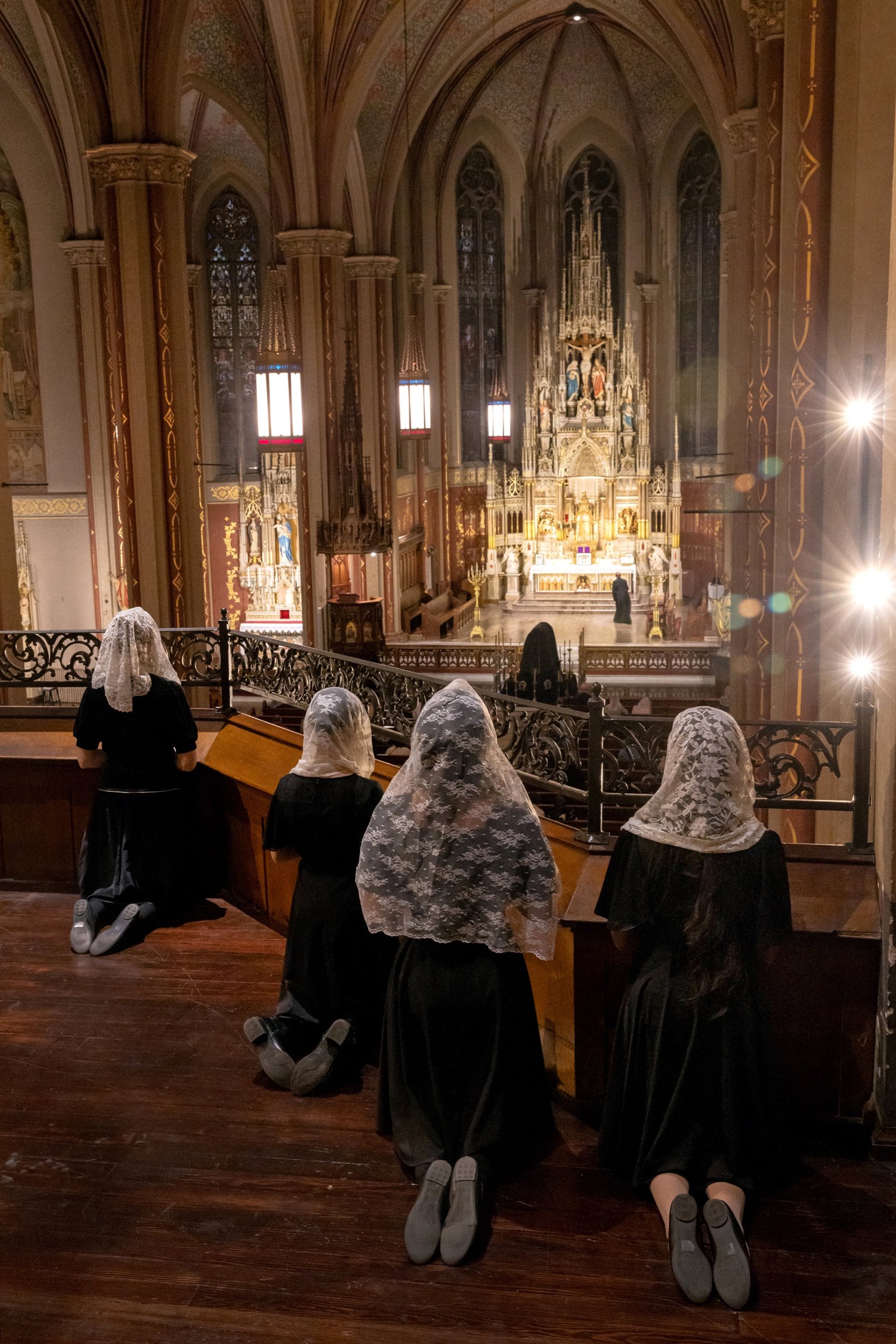  Women knelt before the start of a Mass featuring Wolfgang Amadeus Mozart’s Requiem during the Christ the King Music Festival on Nov. 2 at St. Francis de Sales Oratory in St. Louis, Missouri. 
