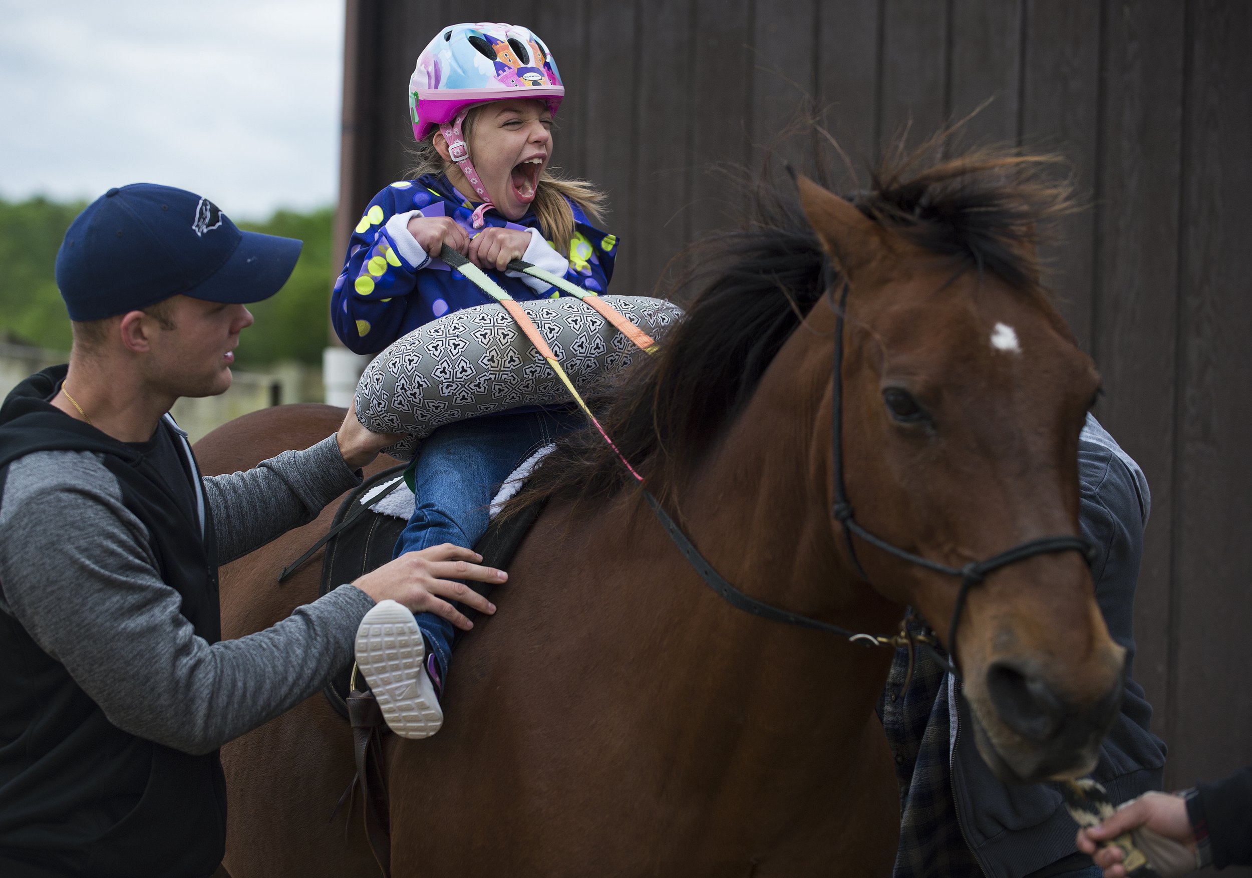  Kennedy Baker, 7, of Goreville, rides Dauber with the assistance of Dallas Broeker, a senior from Chadron, Nebraska, studying nursing, during a session of Specialized Equine Services and Therapeutic Riding on May 1 at Giant City Stables in Makanda, 