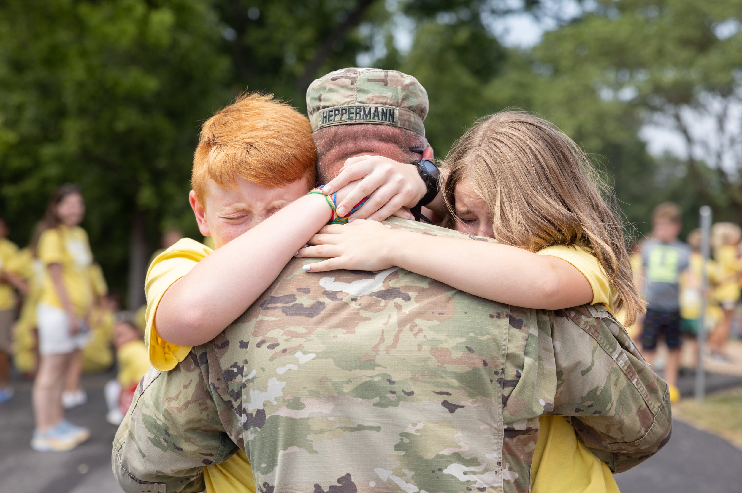  Surprising his children with his return from deployment in Kuwait, U.S. Army SFC Anthony Heppermann was hugged by his children David, 11, and Hailey, 9, during their Totus Tuus summer youth program June 30 at St. Theodore Parish in Flint Hill, Misso