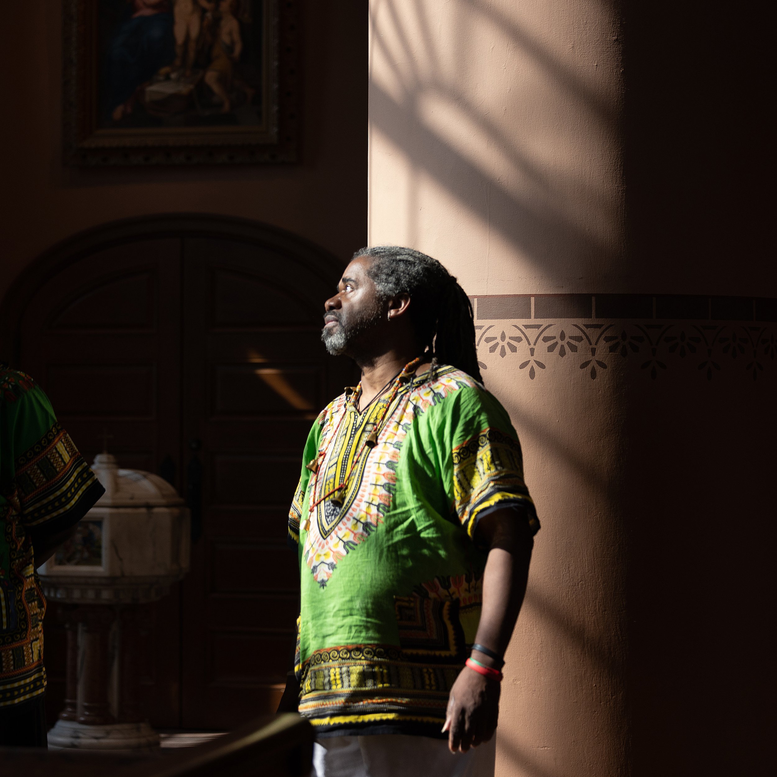 David A.N. Jackson, who provided African drumming for the second annual “Forgive Us Our Trespasses” Maafa procession and prayer service, stood in light from a window in the Basilica of St. Louis, King of France (Old Cathedral) on  June 17 in St. Lou