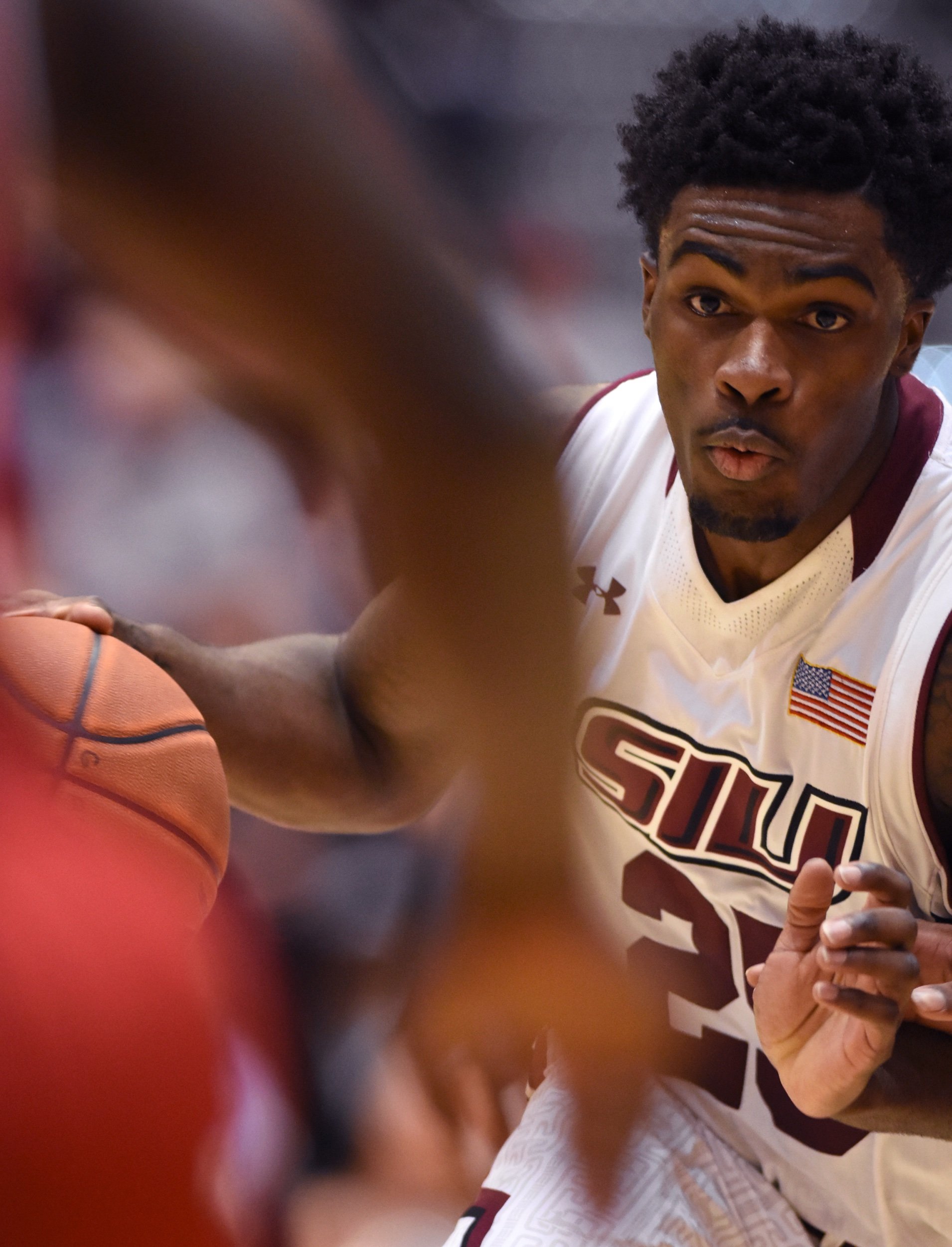  Southern Illinois University senior guard Anthony Beane looks toward an oncoming player as he barrels down the court during SIU’s 71-59 victory against Bradley on Feb. 17 at SIU Arena in Carbondale, Illinois. Beane, who reached 1,000 career points i