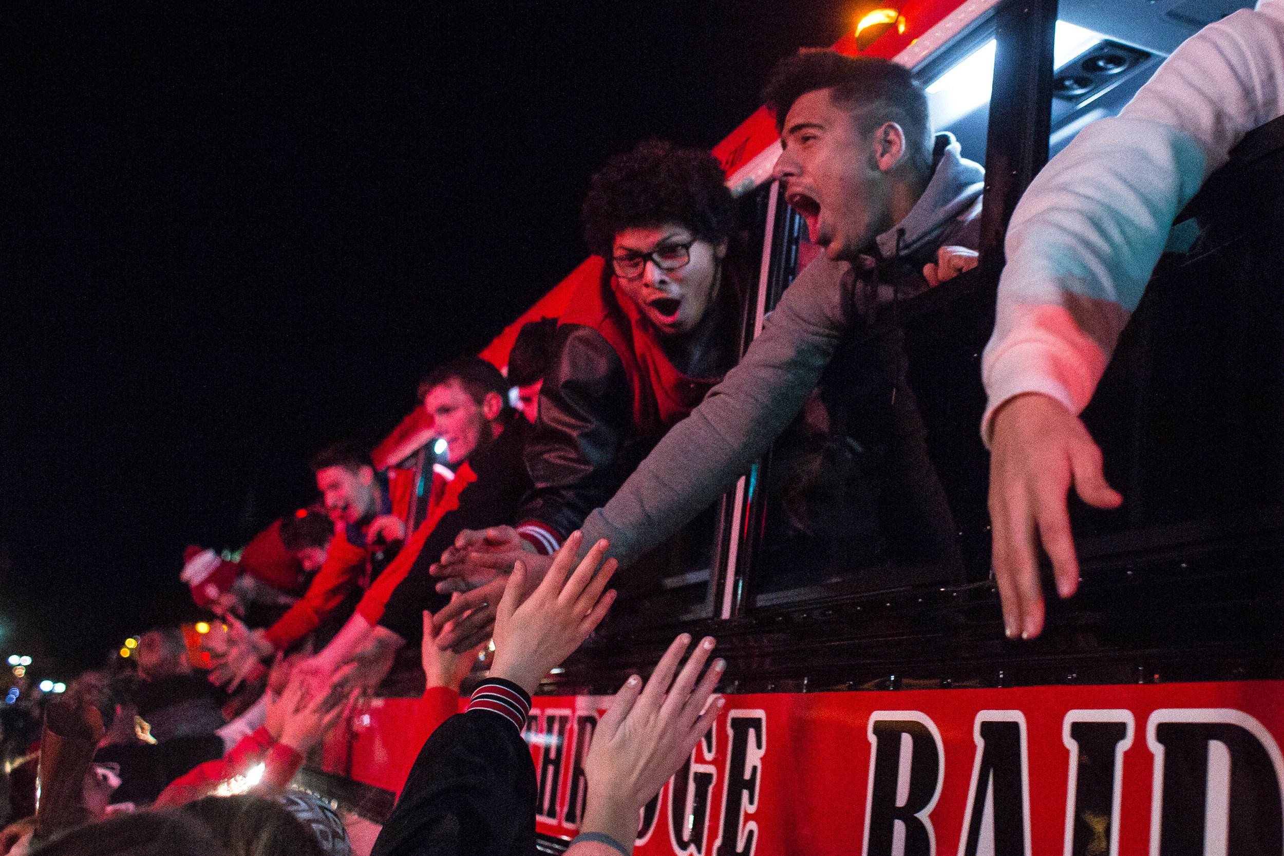 Southridge’s Jeovany Dubon, right, and Jose Calderon high fived fans as the Raiders made their way through Huntingburg, Indiana, on Nov. 25 when returning to town after their 15-14 Class 2A state championship victory over Woodlan. 