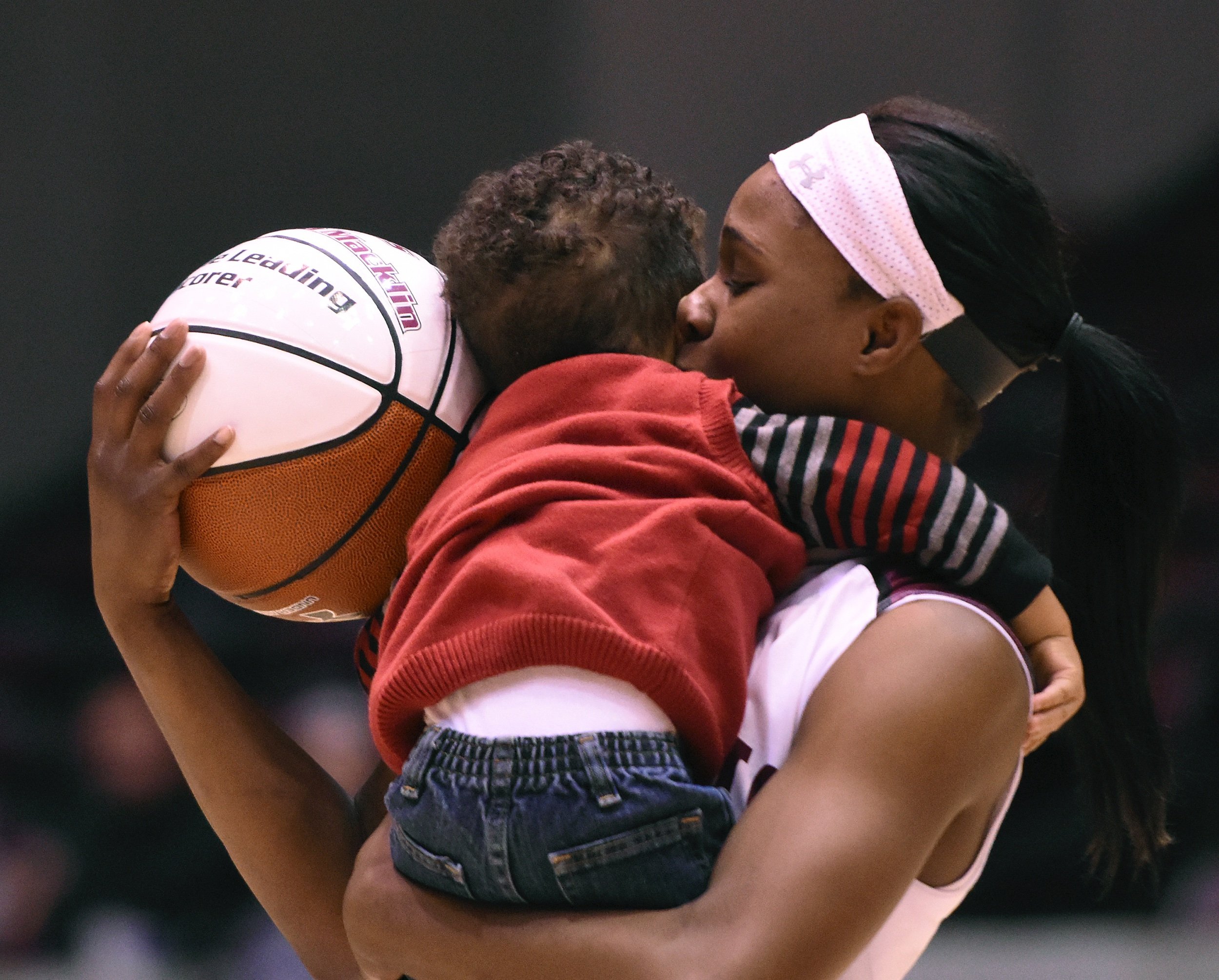  Southern Illinois University senior guard Cartaesha Macklin kisses her 1-year-old son, Carson Verhines after SIU’s 74-56 win against Evansville on Jan. 16 at SIU Arena in Carbondale, Illinois. During the game, Macklin became the top scorer in Saluki